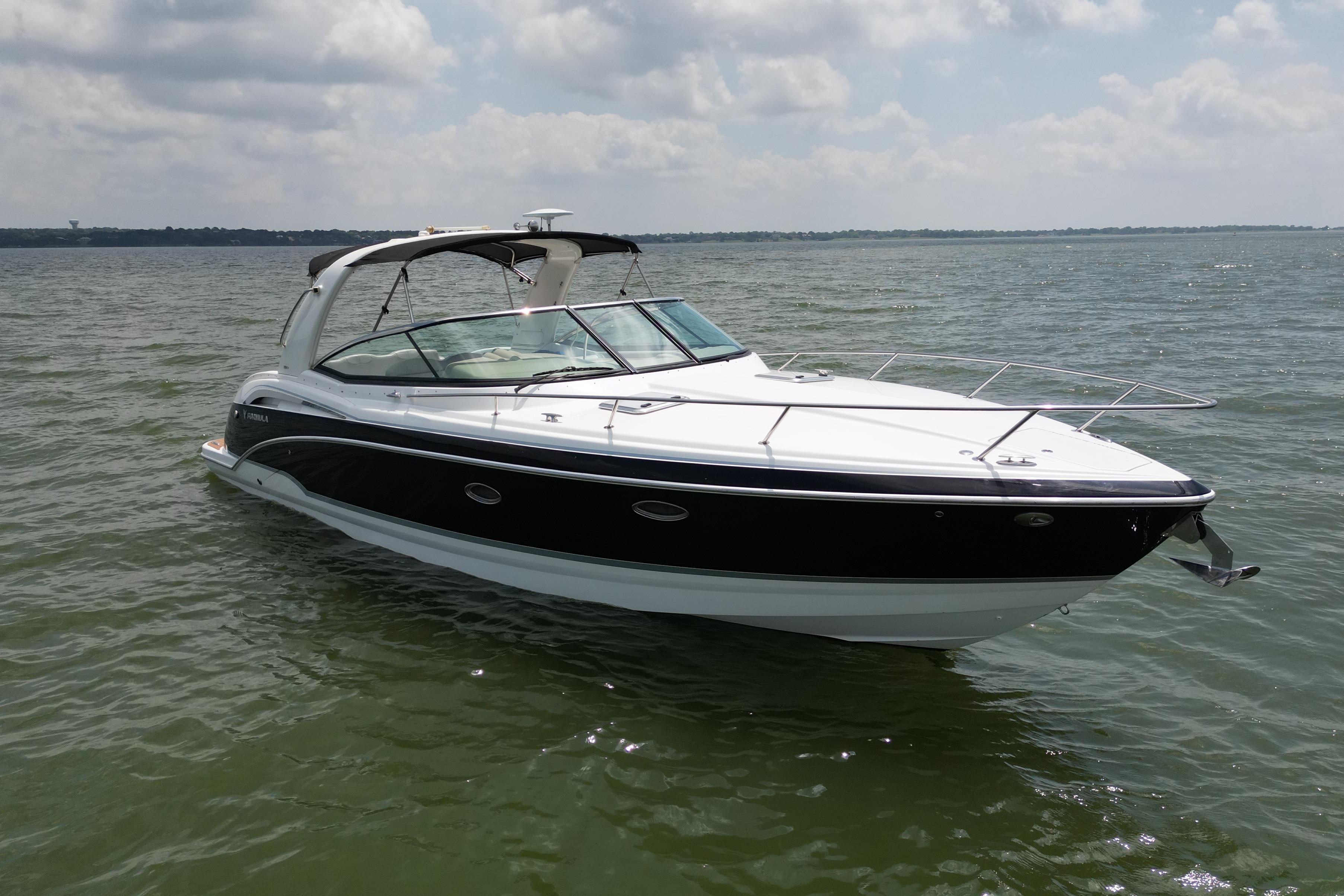 2008 Formula 350 Sun Sport boat on calm water under cloudy sky.