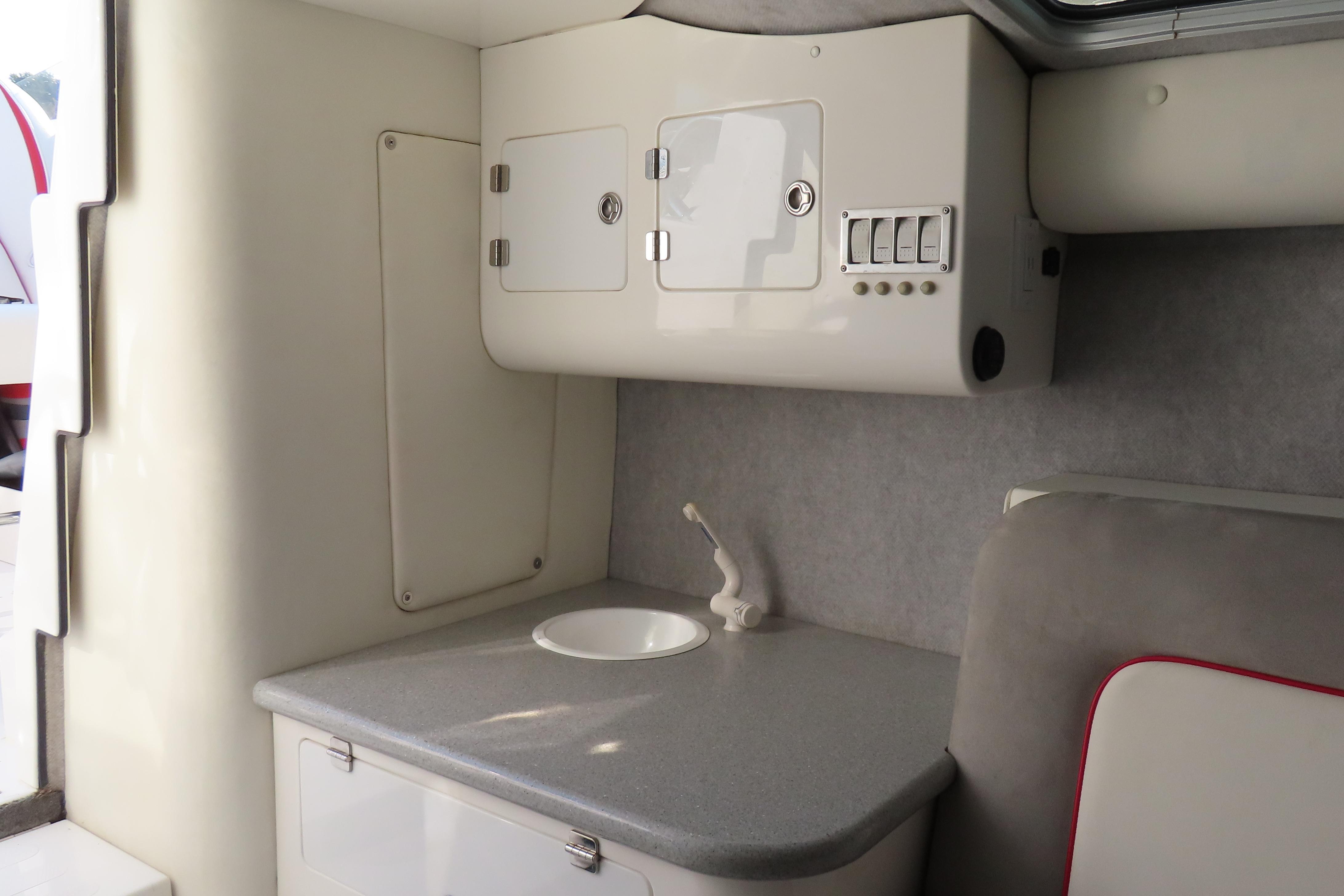 Interior of 2013 Nordic 39 Poker Run boat with compact sink and storage.