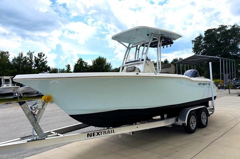 2024 Key West 239 FS boat on trailer, parked outdoors under a cloudy sky.