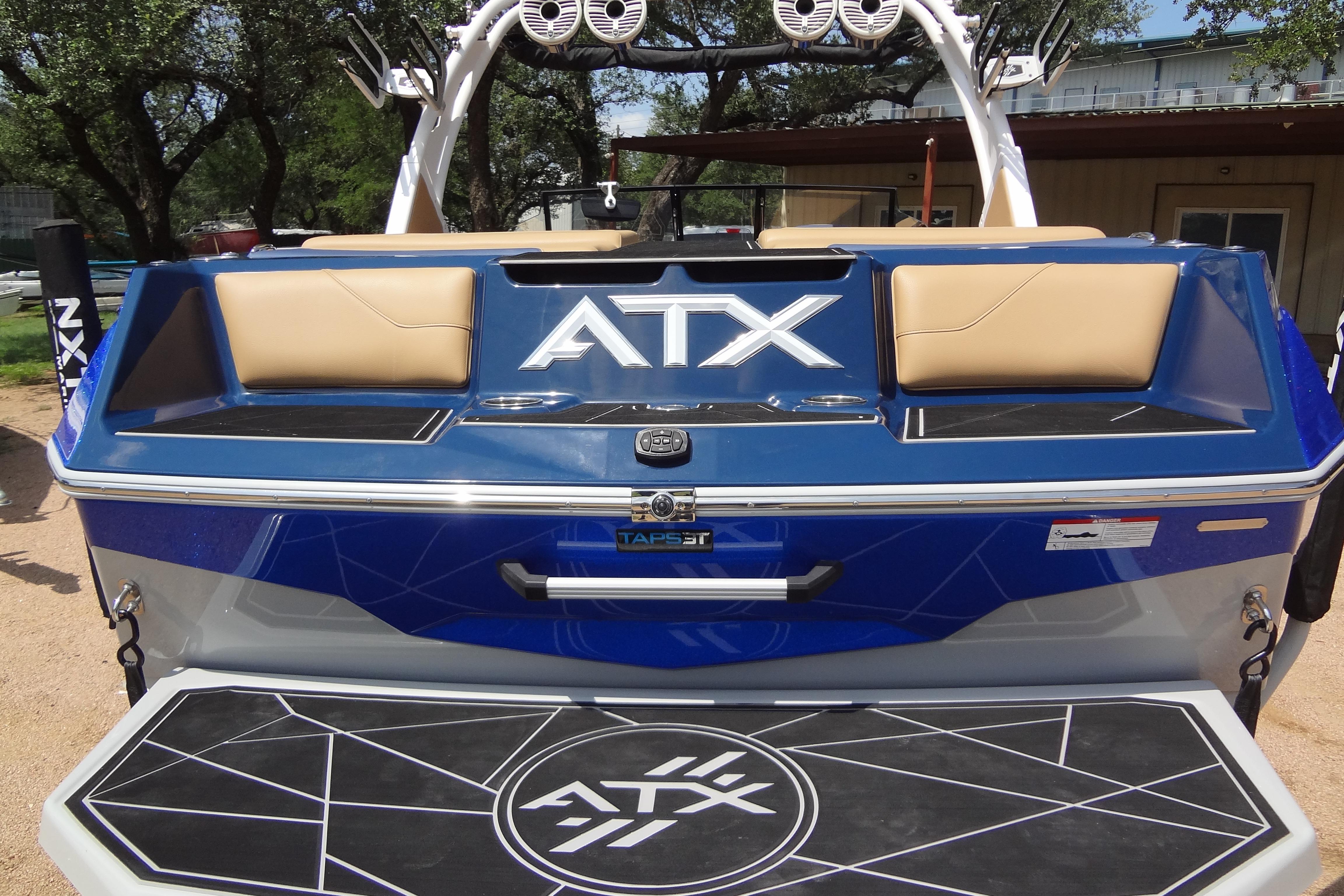 2022 ATX Surf Boats 24 Type-S, rear view with logo and seating, in a sunny outdoor setting.