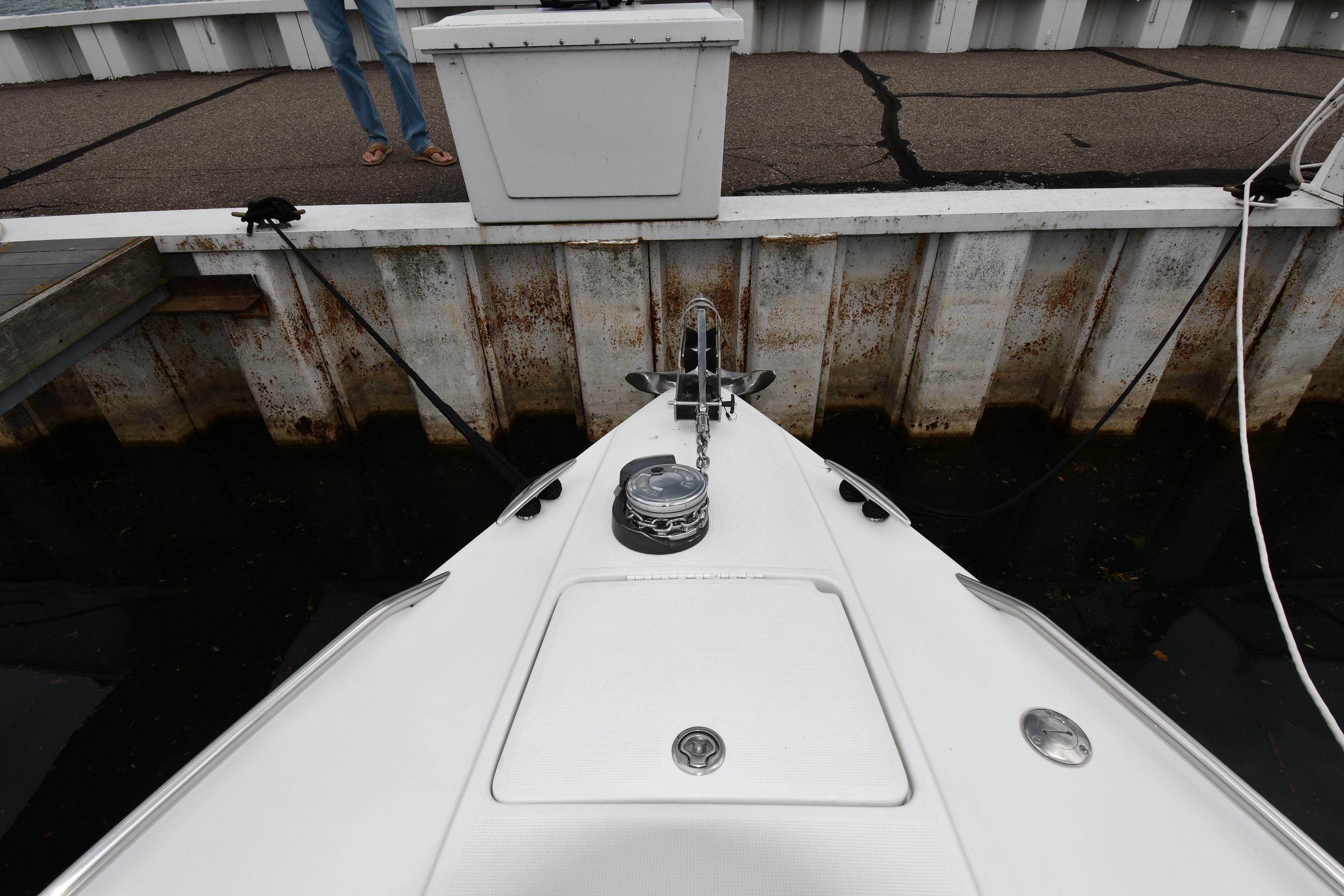 Bow of a 2004 Formula 330 Sun Sport boat docked at a marina.