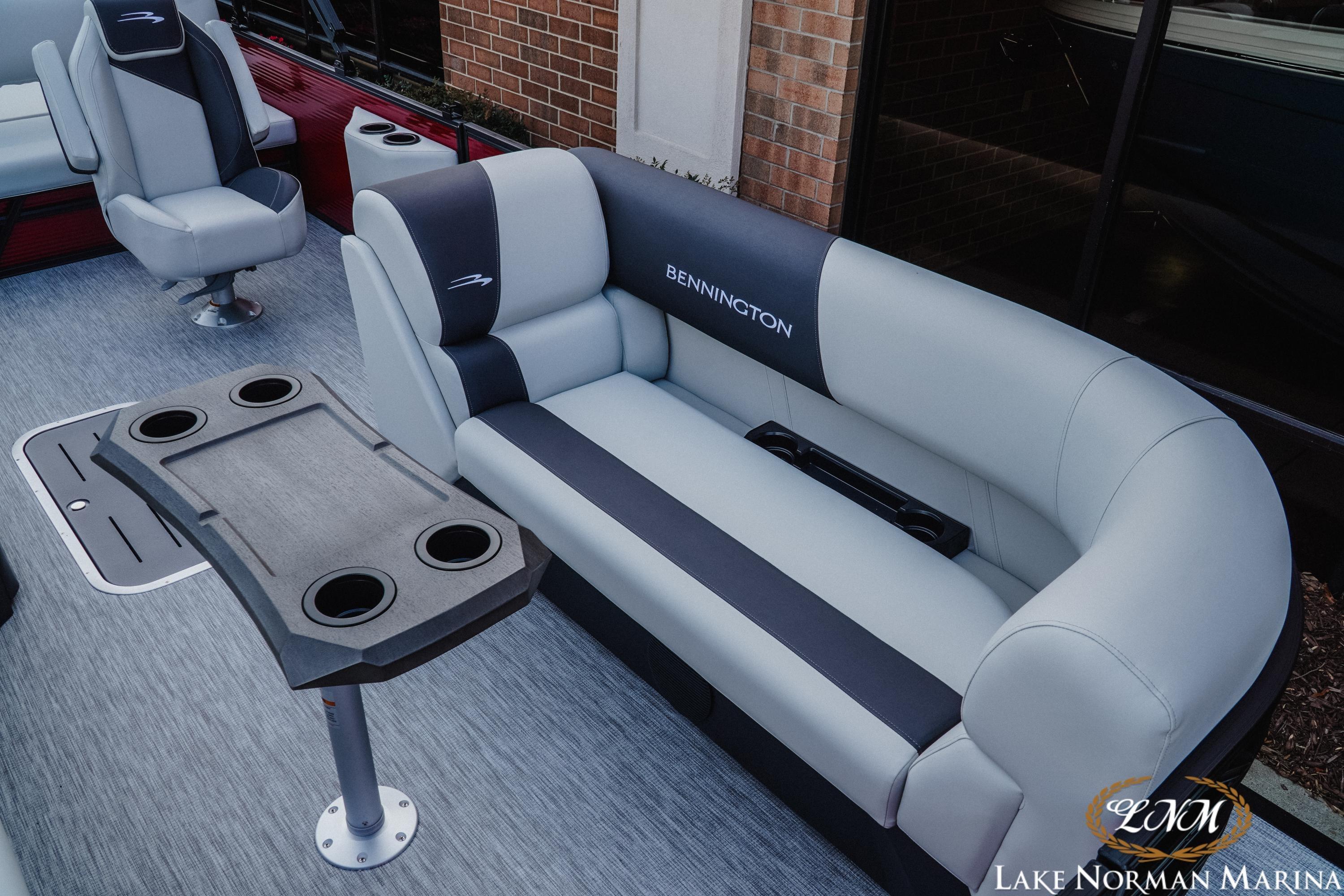 2026 Bennington 22SSB pontoon boat interior with plush seating and cup holders.
