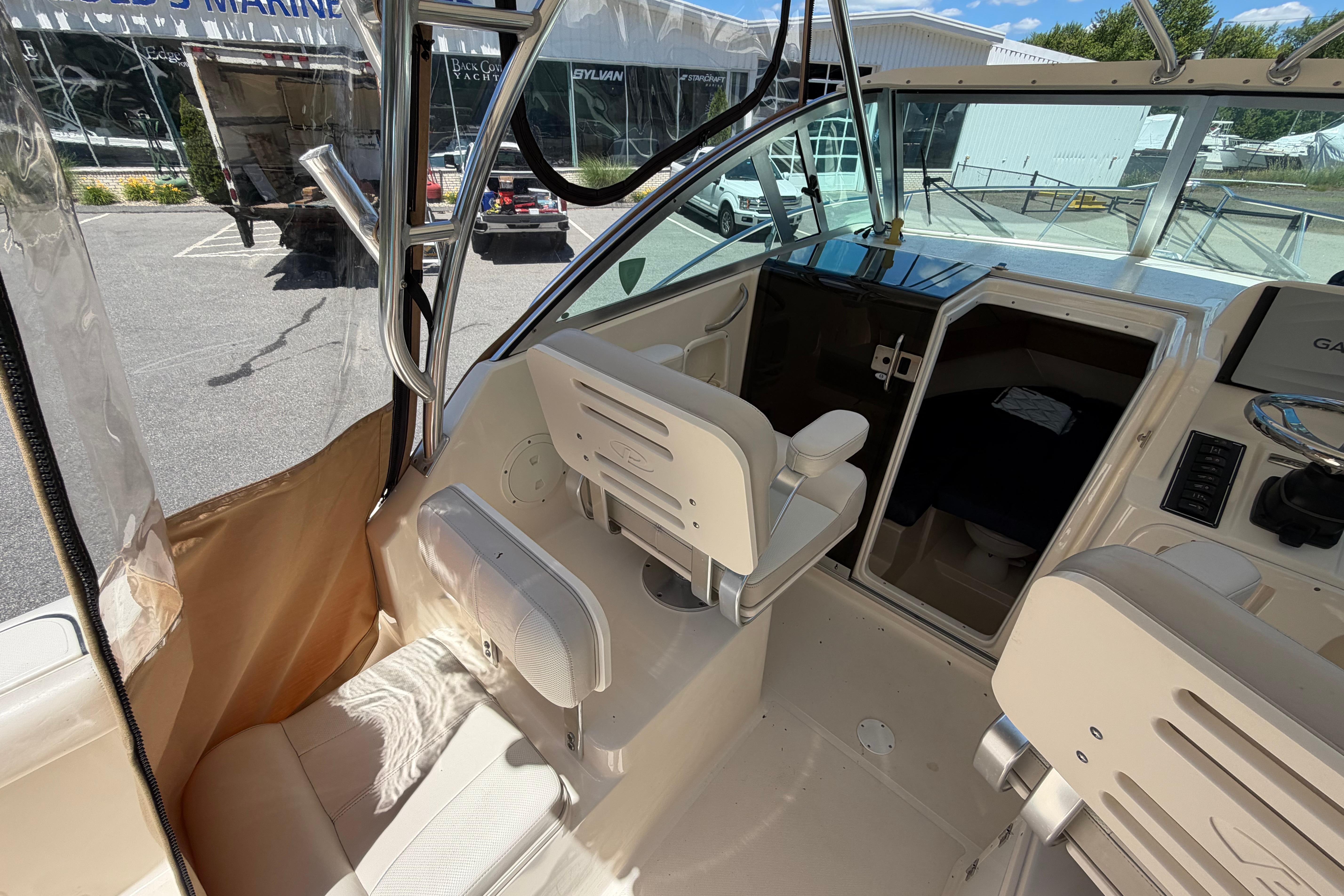 2010 Pursuit OS 255 Offshore boat interior with helm and seating area.
