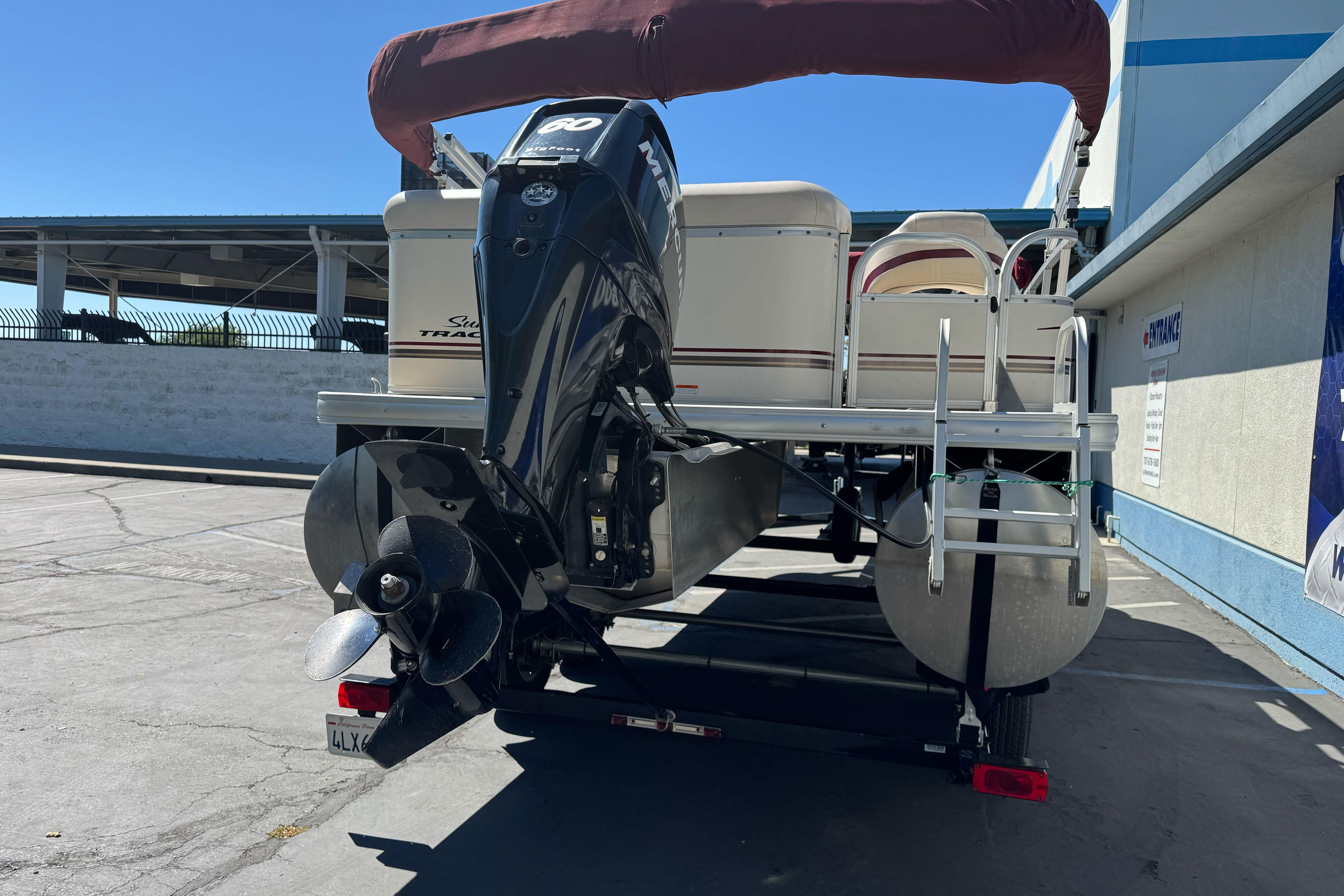 2011 Sun Tracker Party Barge 21 pontoon boat with outboard motor on trailer.