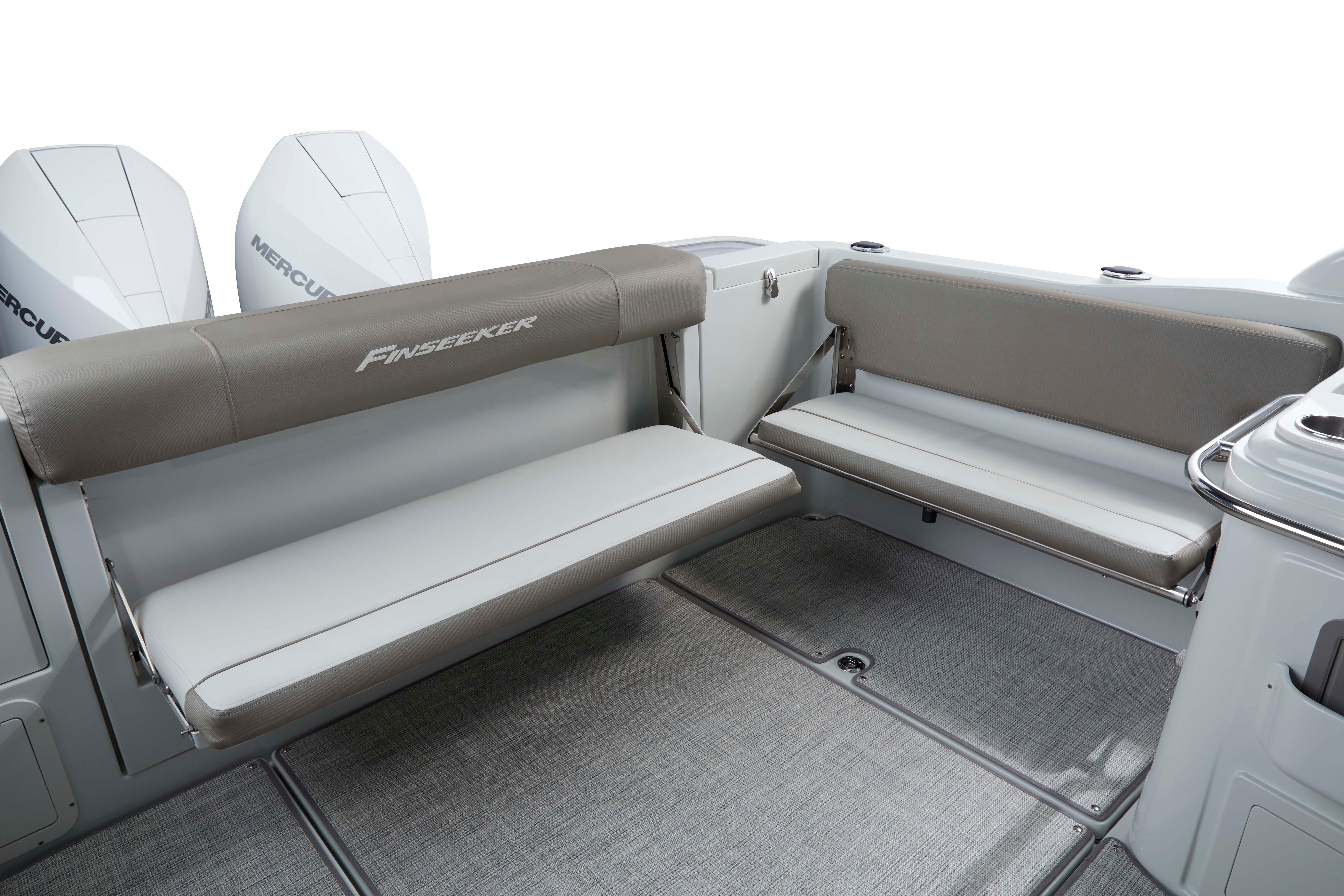 2024 Finseeker 280 DC boat interior with cushioned seating and dual Mercury engines.