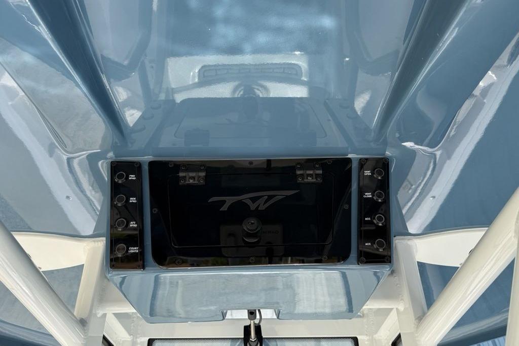 2026 Tidewater 232 LXF boat console with control panel and storage compartment.