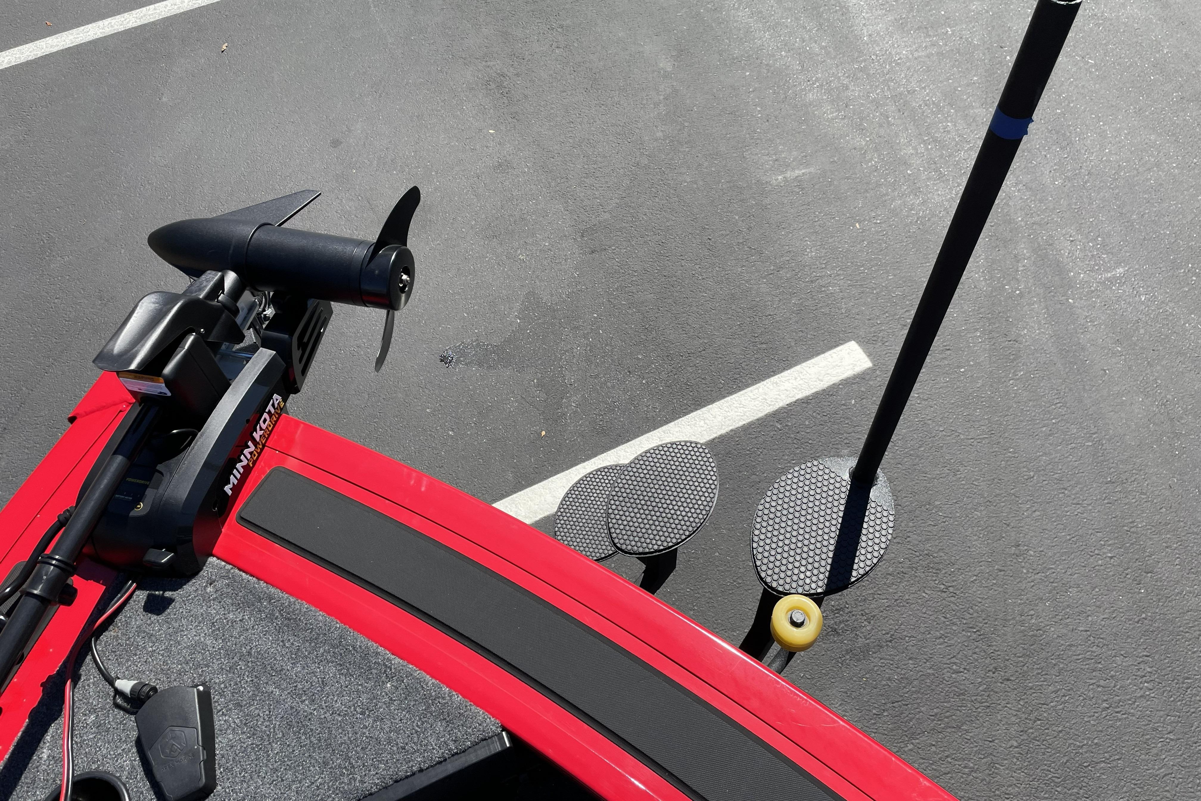 2026 Tracker Targa V-18 WT boat with Minn Kota trolling motor on asphalt.