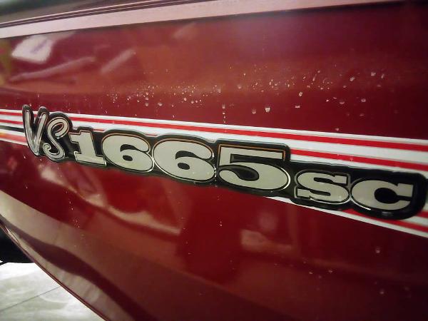 2025 Ranger VS1665 SC boat model emblem on red surface.
