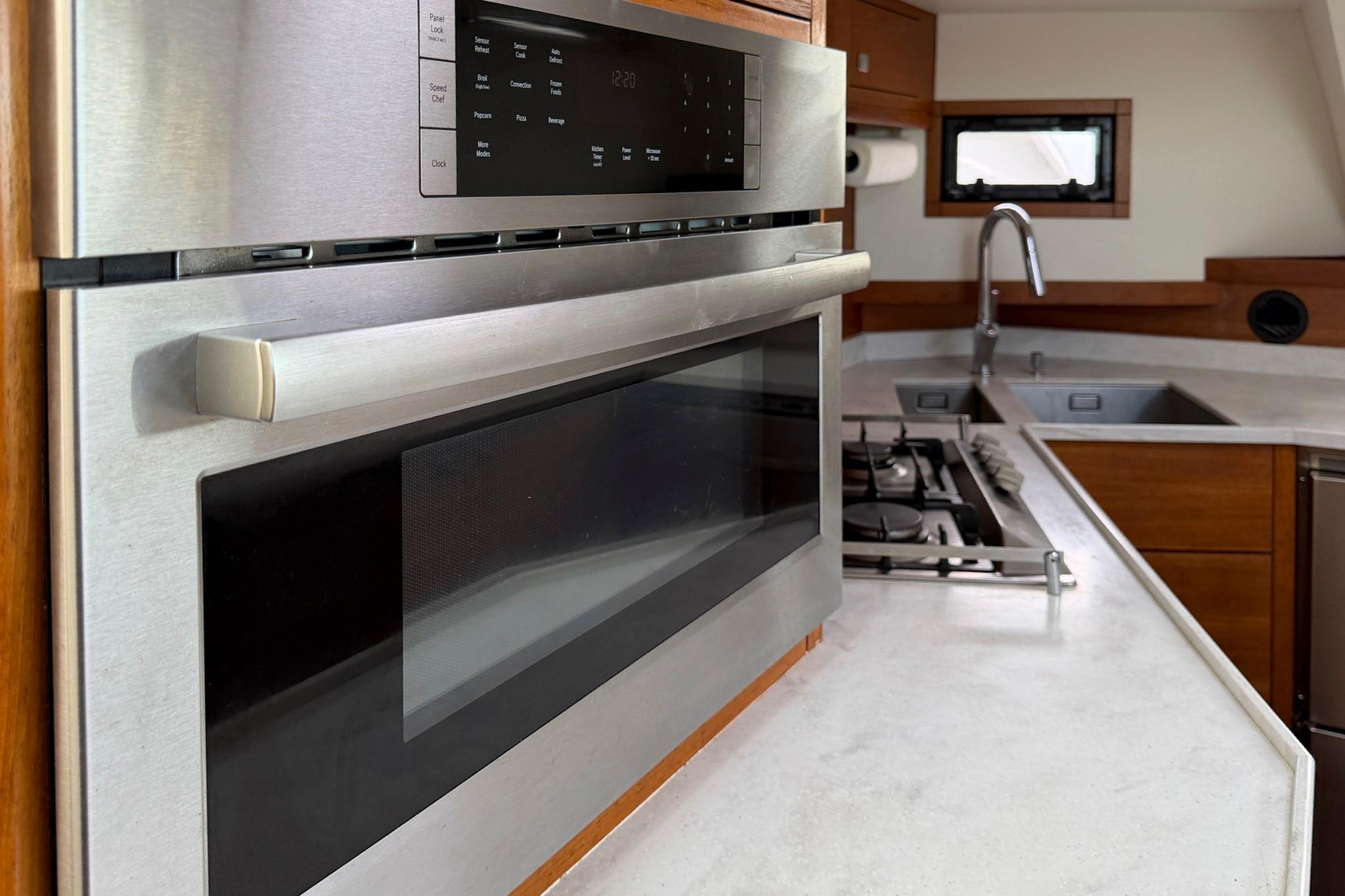 Modern kitchen in 2015 Gunboat 57 yacht with stainless steel appliances.