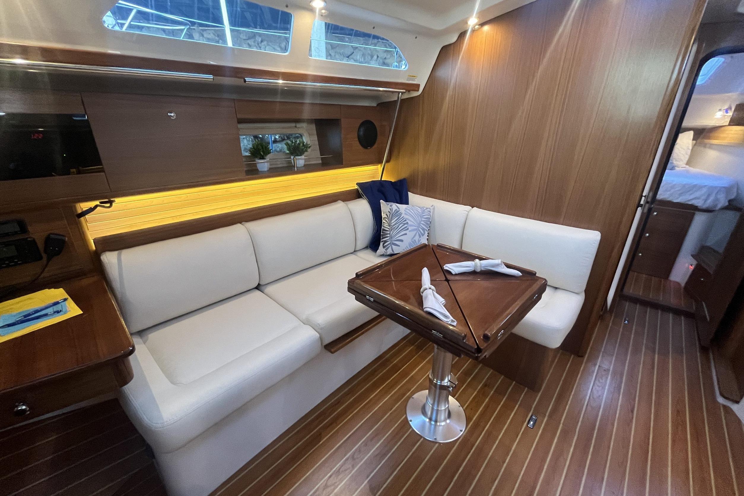 Luxurious interior of 2026 Catalina 386 yacht with elegant seating and wooden finishes.