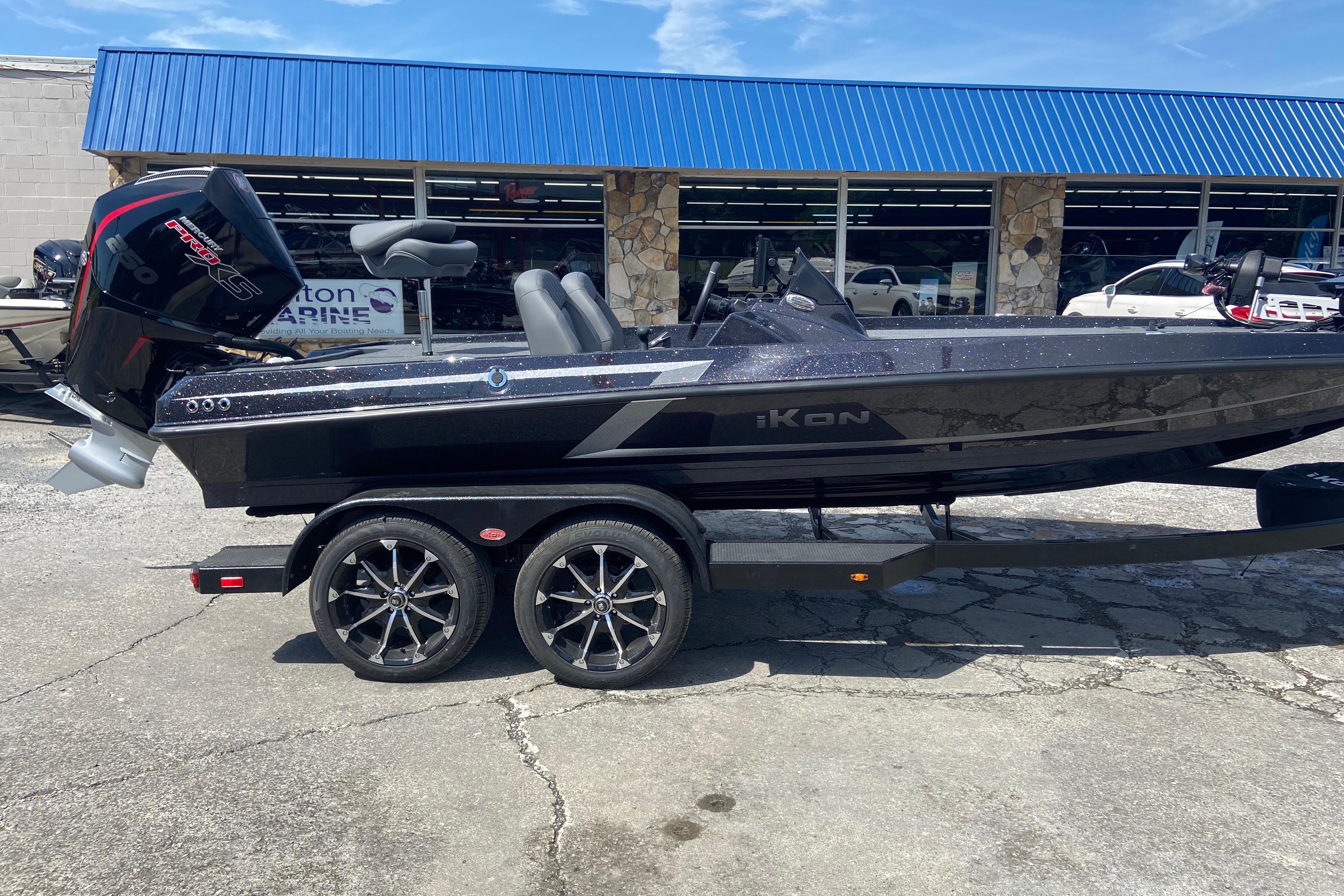 2026 iKon VLX 20 boat on trailer, parked outside a marine dealership.