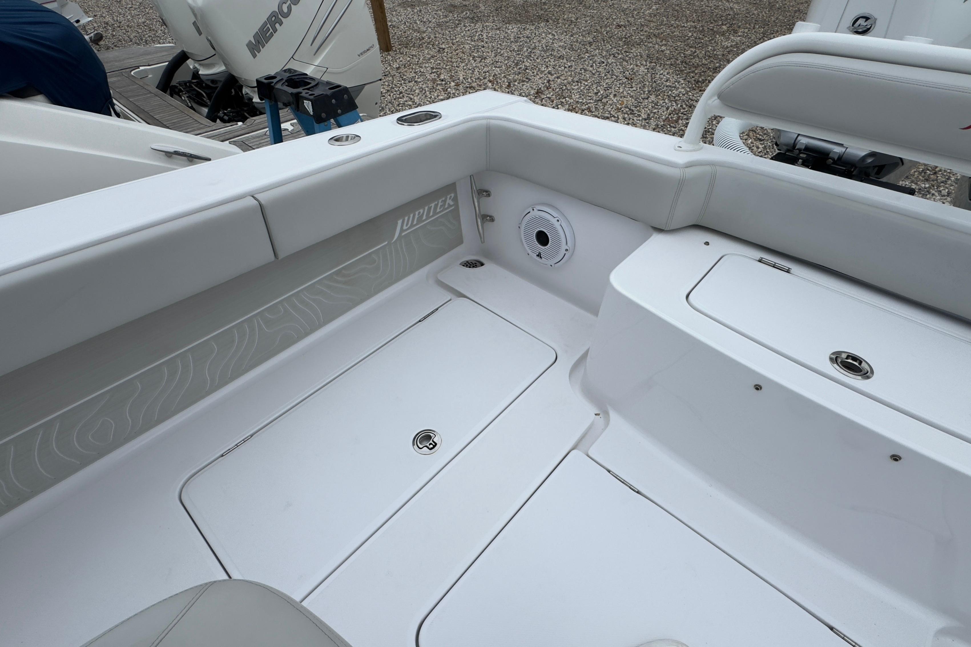 2024 Jupiter 32 FS boat interior with white seating and storage compartments.