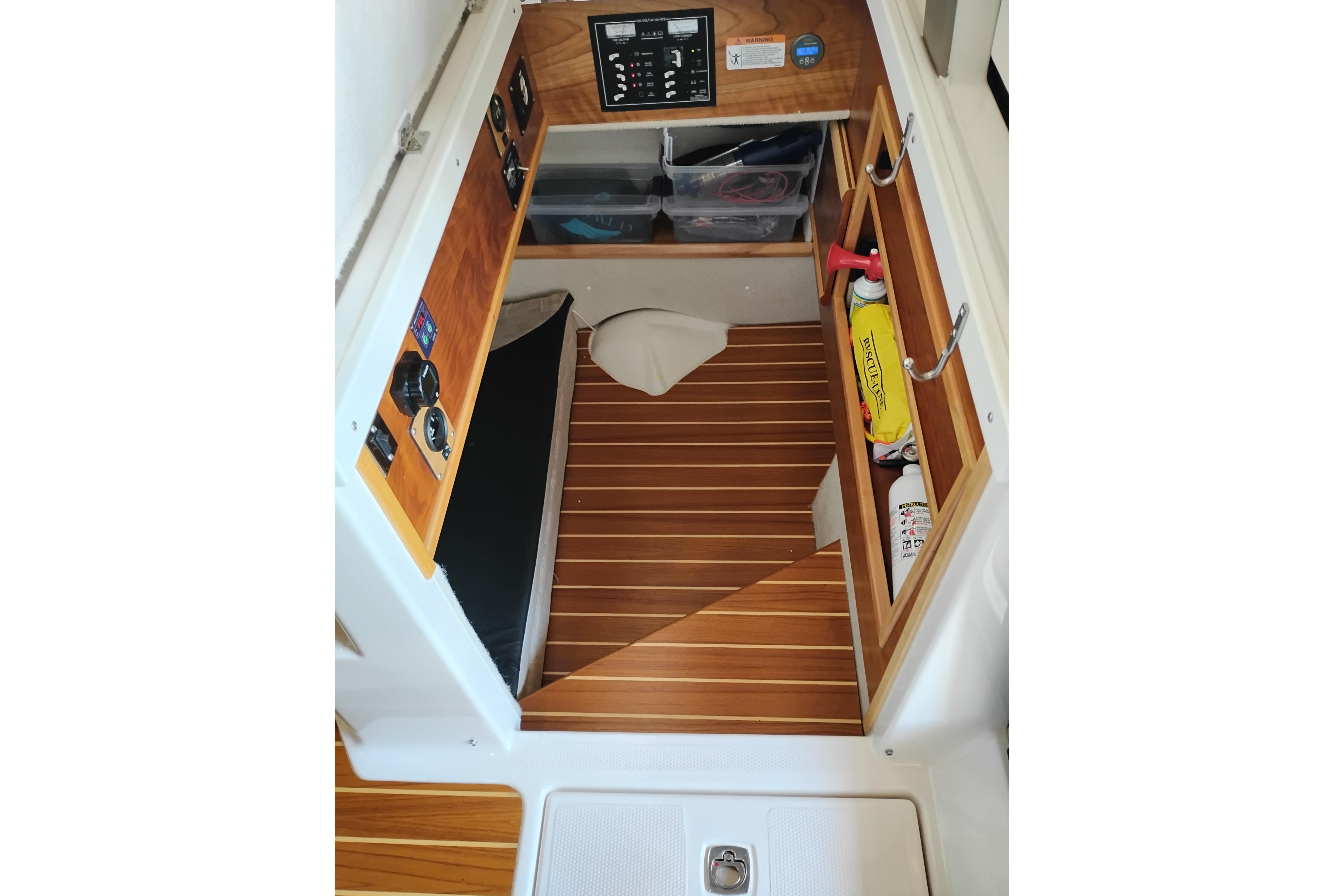 2022 Cutwater C-32 Coupe interior with wooden flooring and storage compartments.