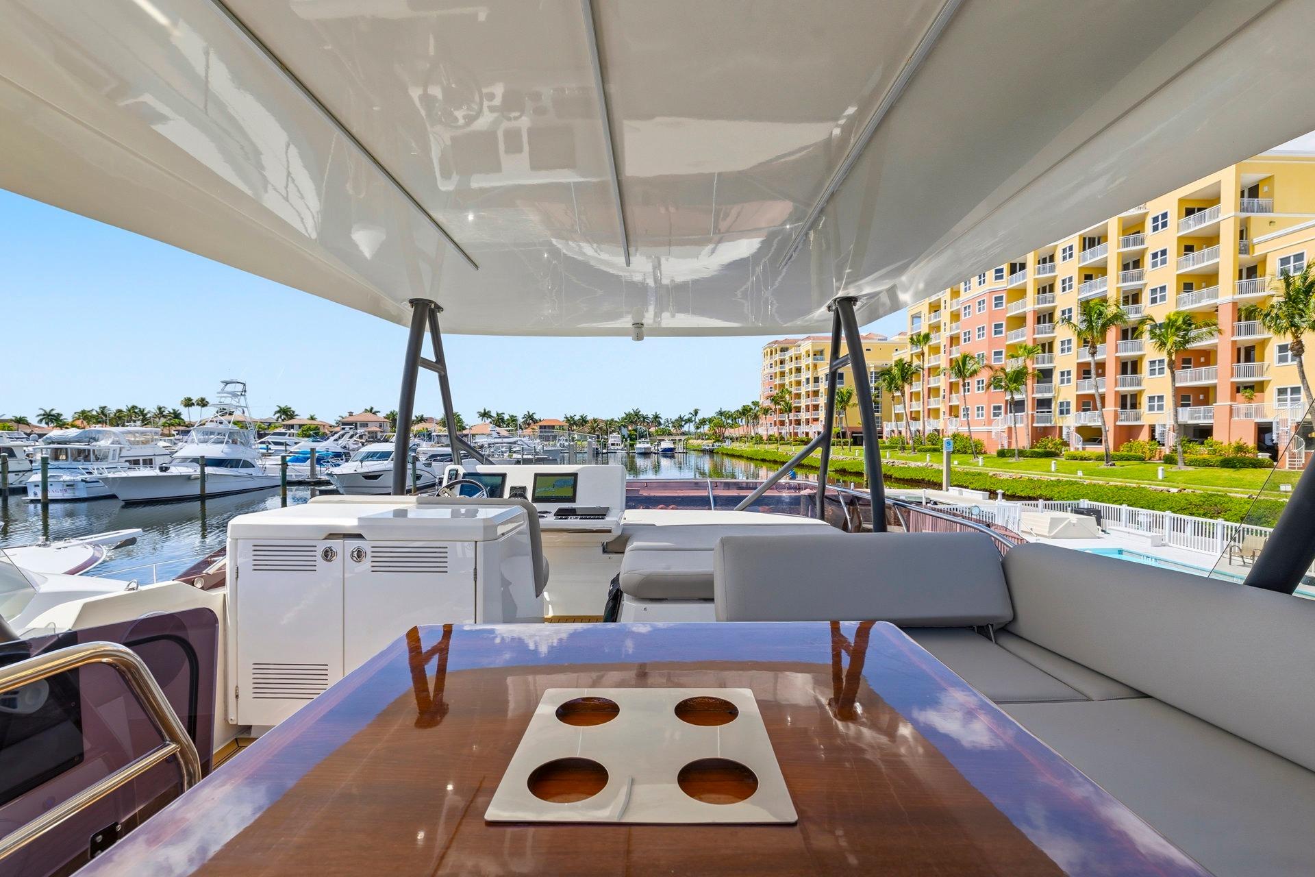 Luxurious 2022 Prestige 520 yacht interior with marina and waterfront view.