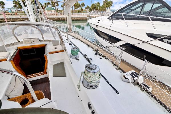 1989 Concordia 52 sailboat deck view with winches and cockpit, docked beside another boat.