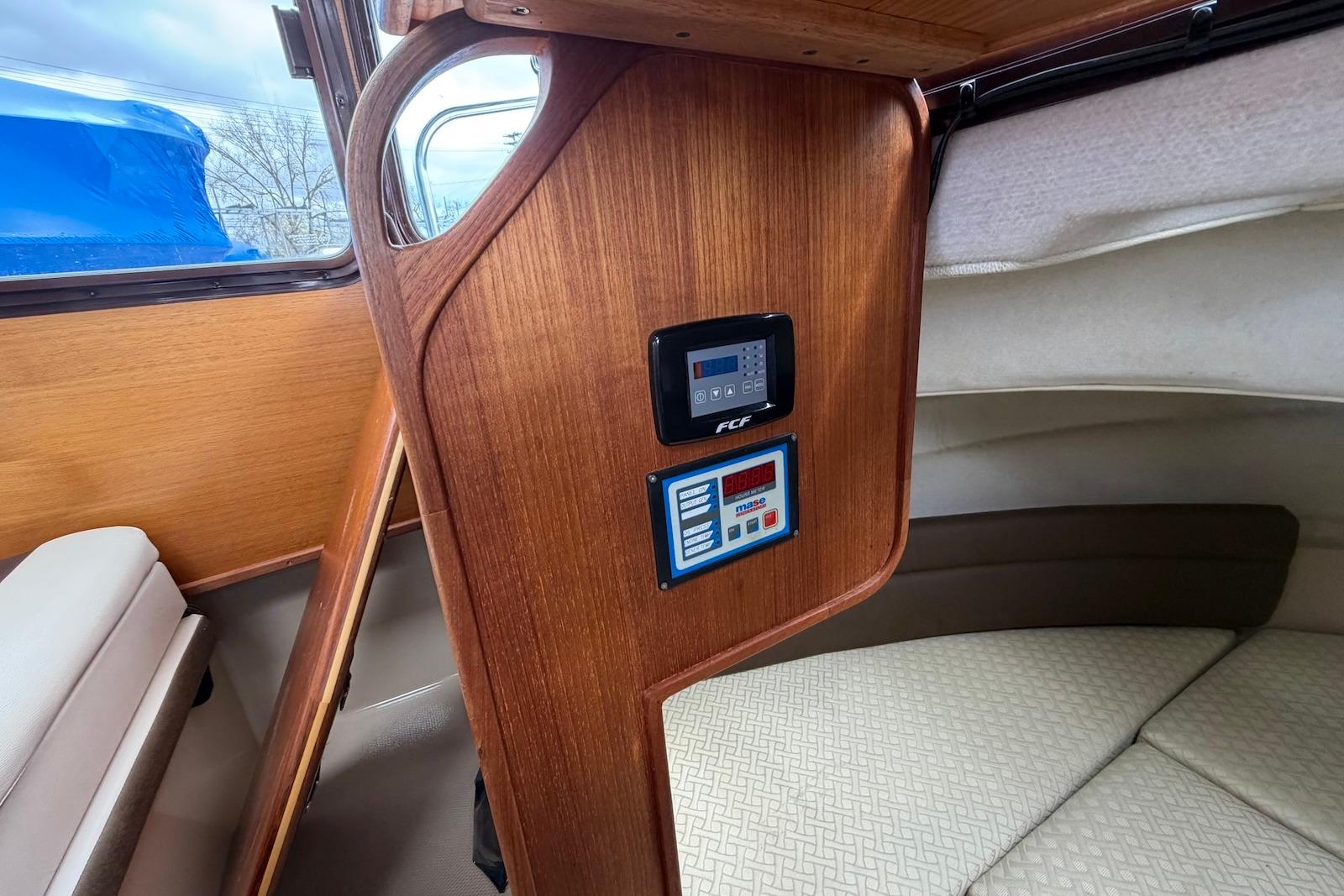 Interior of 2014 Ranger Tugs R-27 boat with control panel and wooden finish.