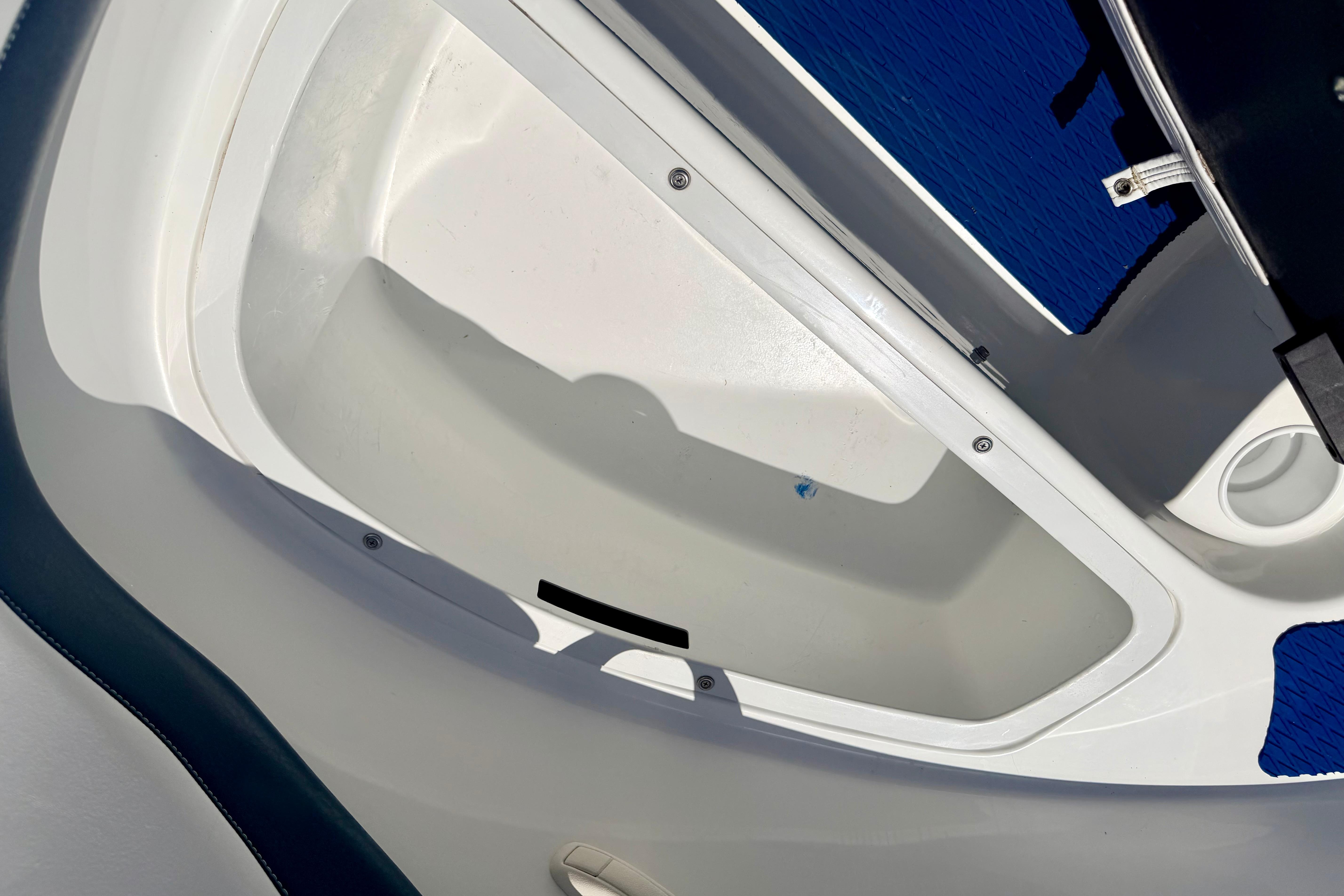 2004 Bombardier SEADOO Utopia 185 boat interior storage compartment, white and blue design.