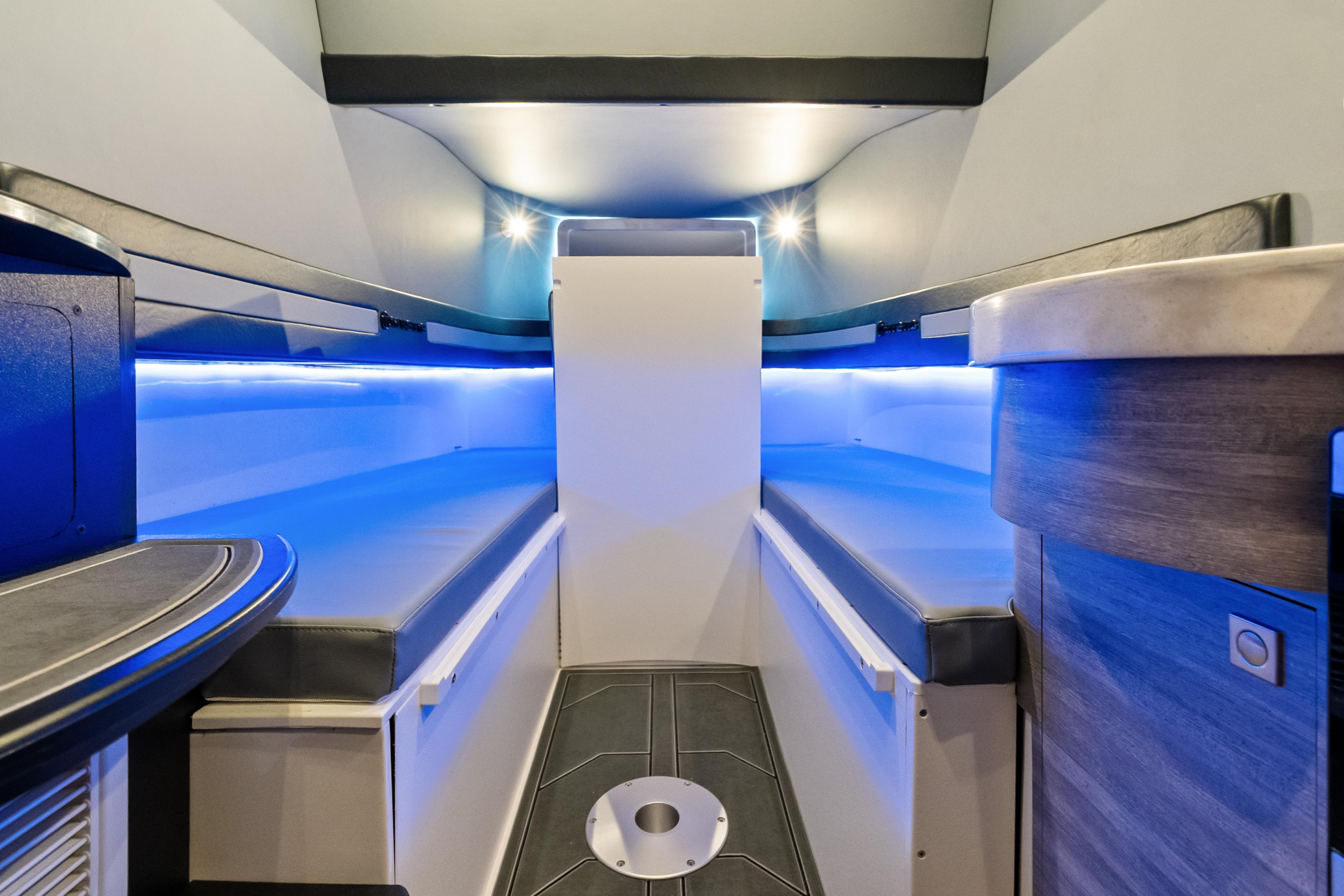 Interior of 2027 Mystic Powerboats M4200, featuring sleek design and ambient blue lighting.