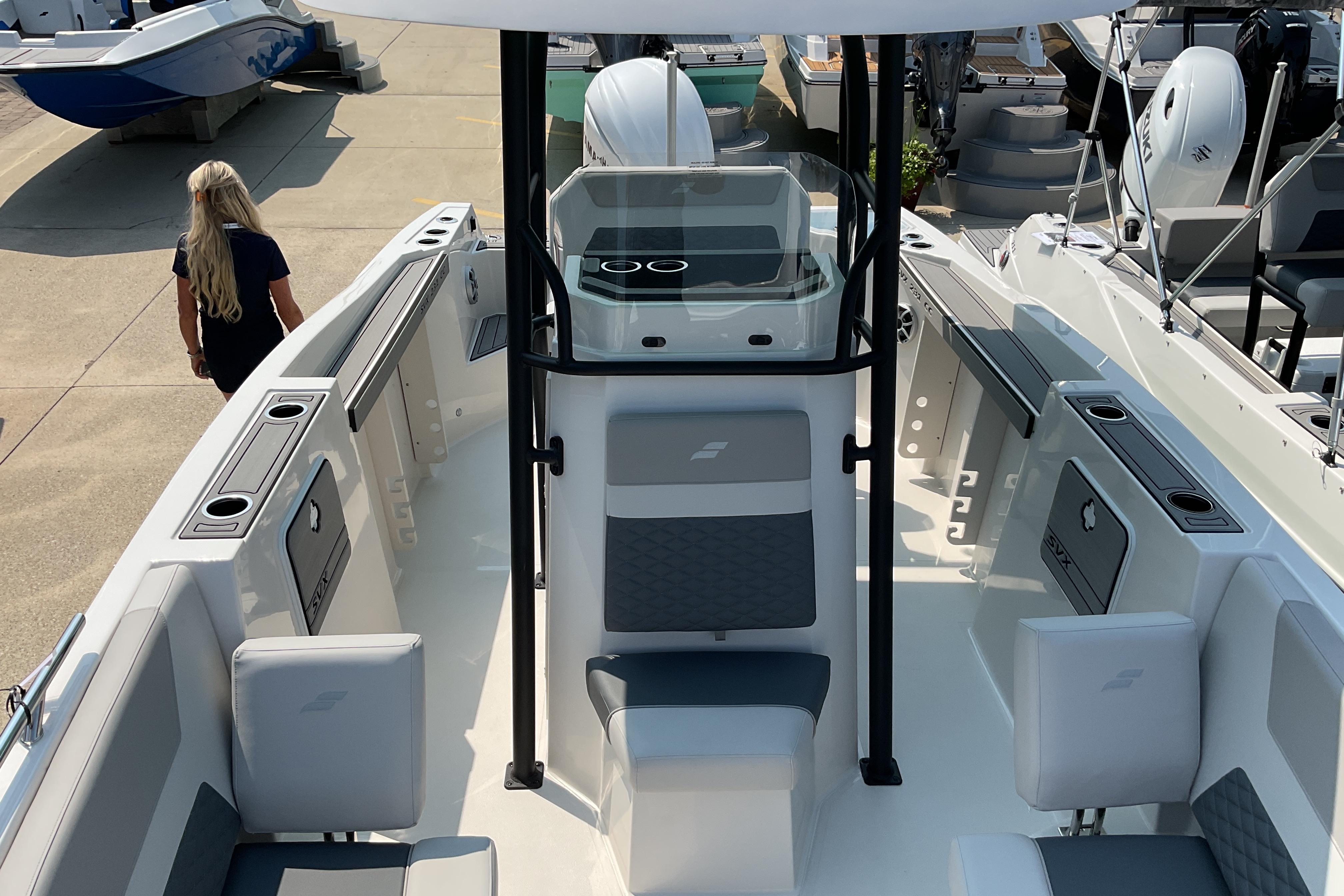 2026 Starcraft SVX 231 OB CC boat interior with seating and console, docked outdoors.
