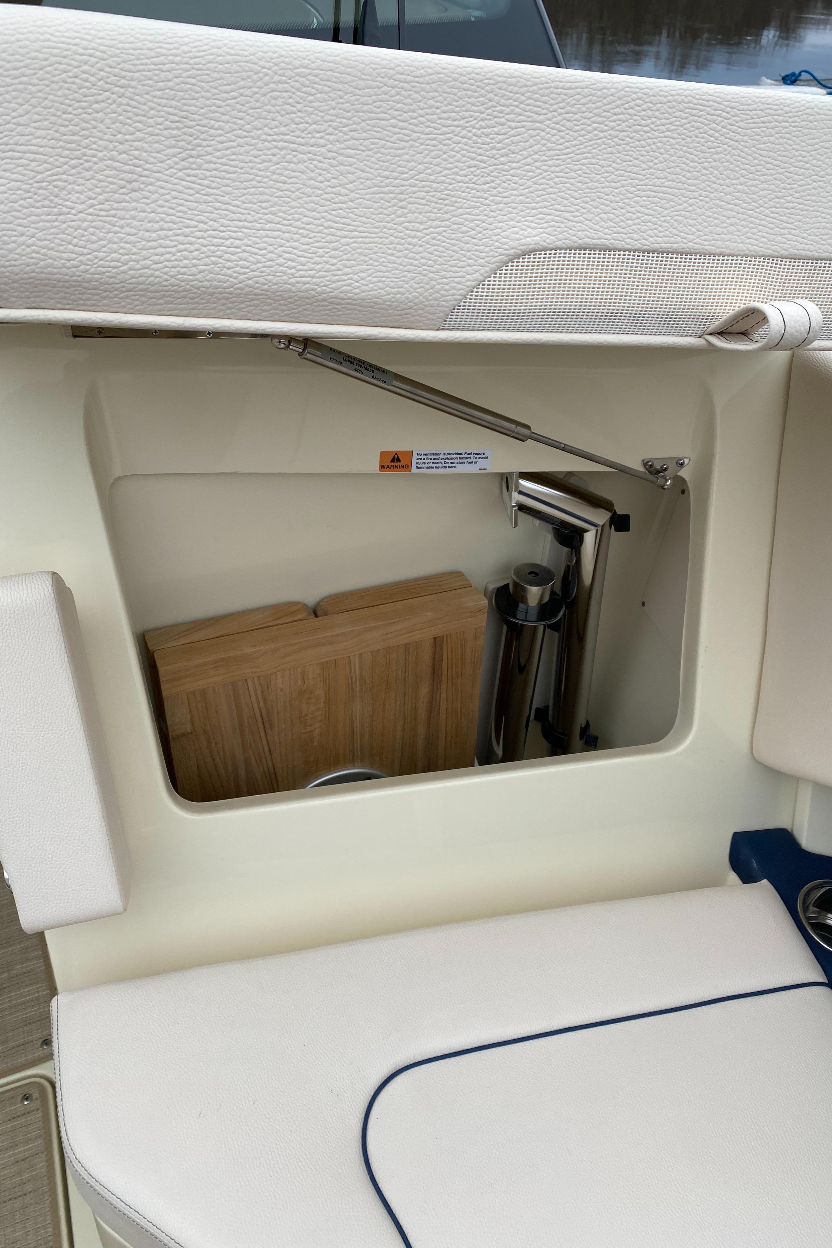 Storage compartment on a 2024 Chris-Craft Calypso 32 boat.