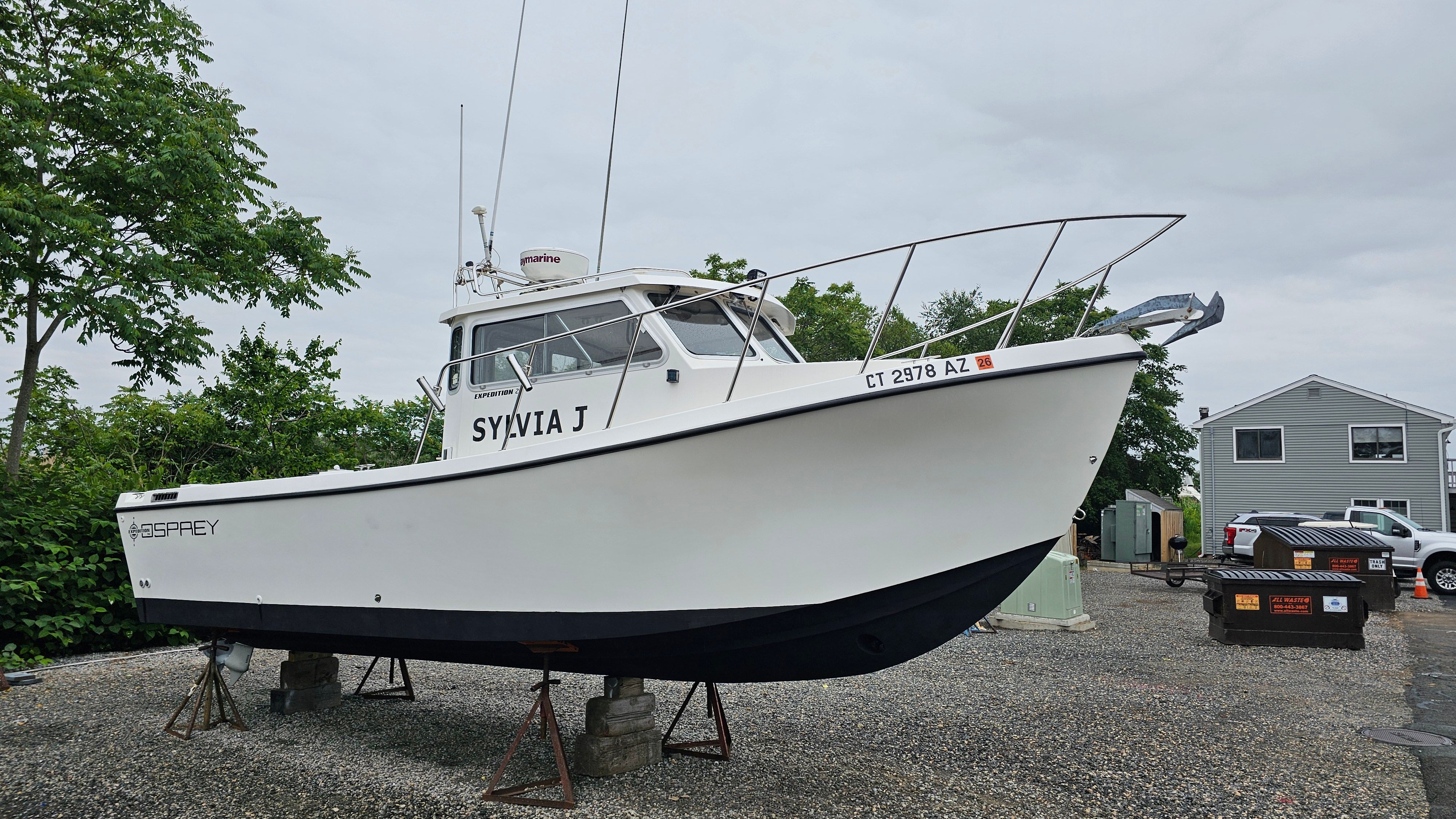 2004 Osprey 26 Expedition boat on stands outdoors.
