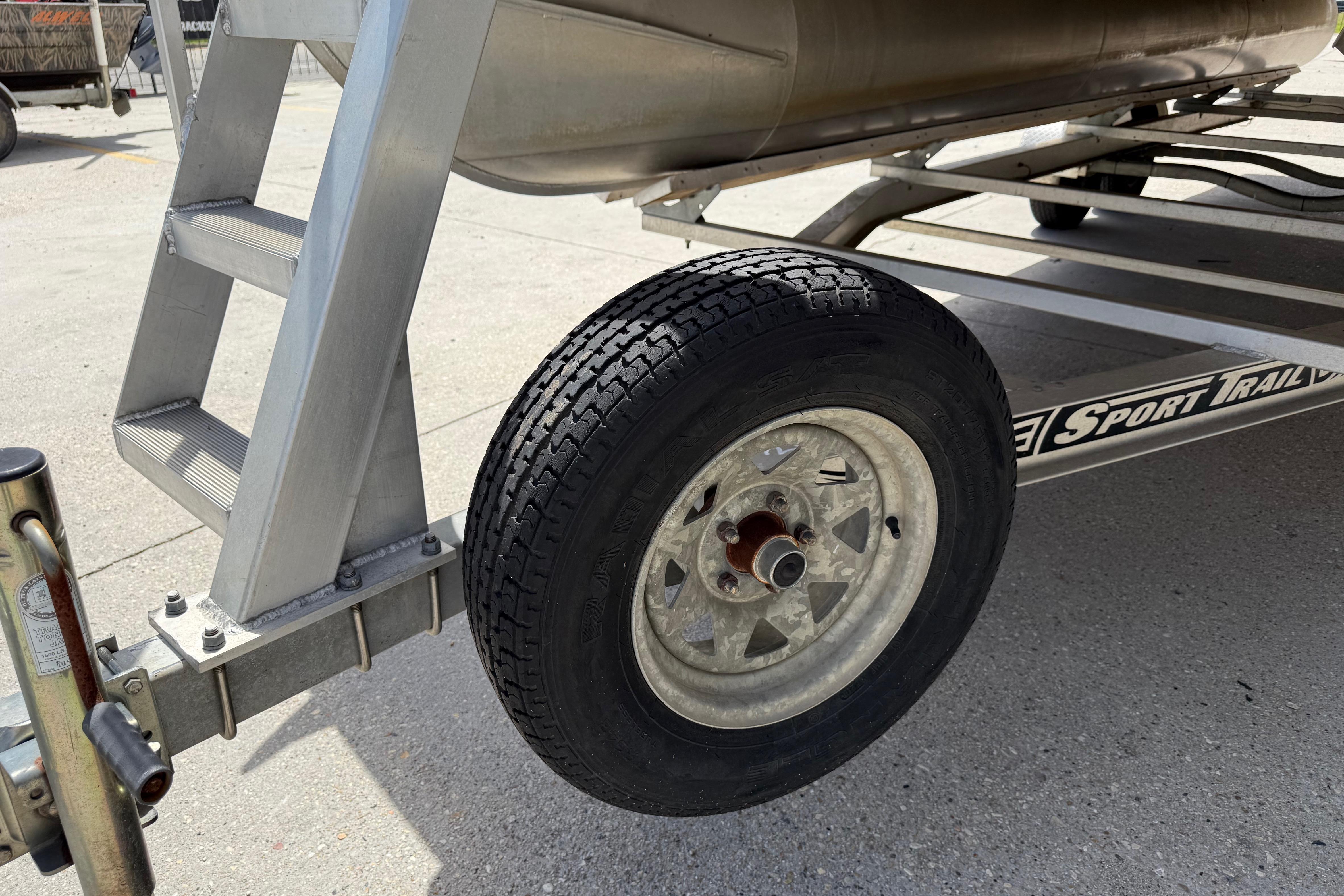 Trailer wheel and ladder of a 2012 South Bay 522 CR boat.