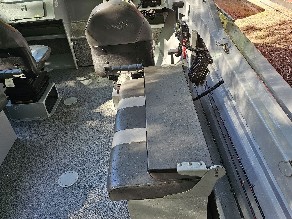 Interior view of a Hewescraft Sea Pro 200 boat with bench seating and control console.