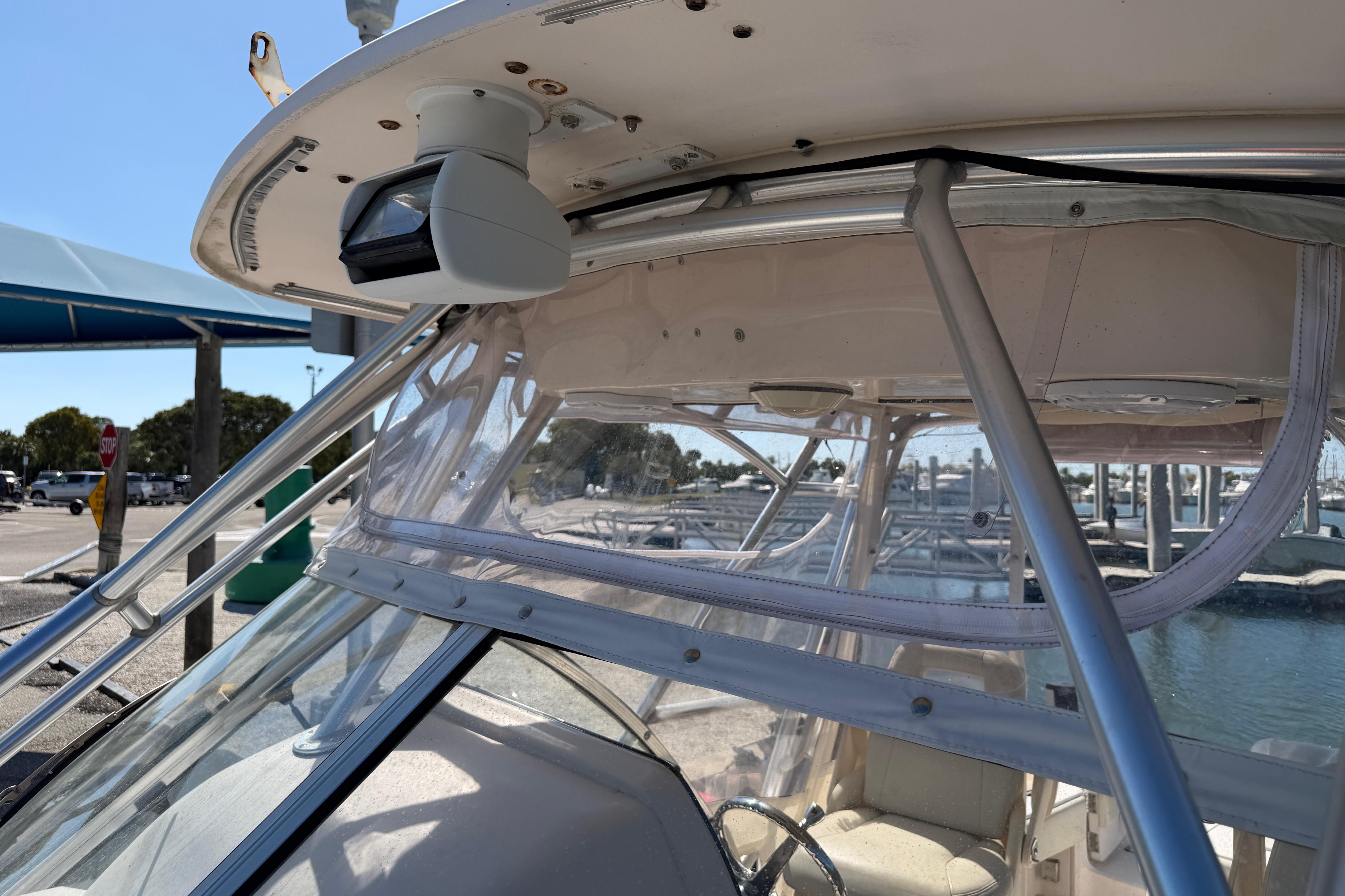 2006 Grady-White Sailfish 282 boat with radar, docked at marina under clear sky.
