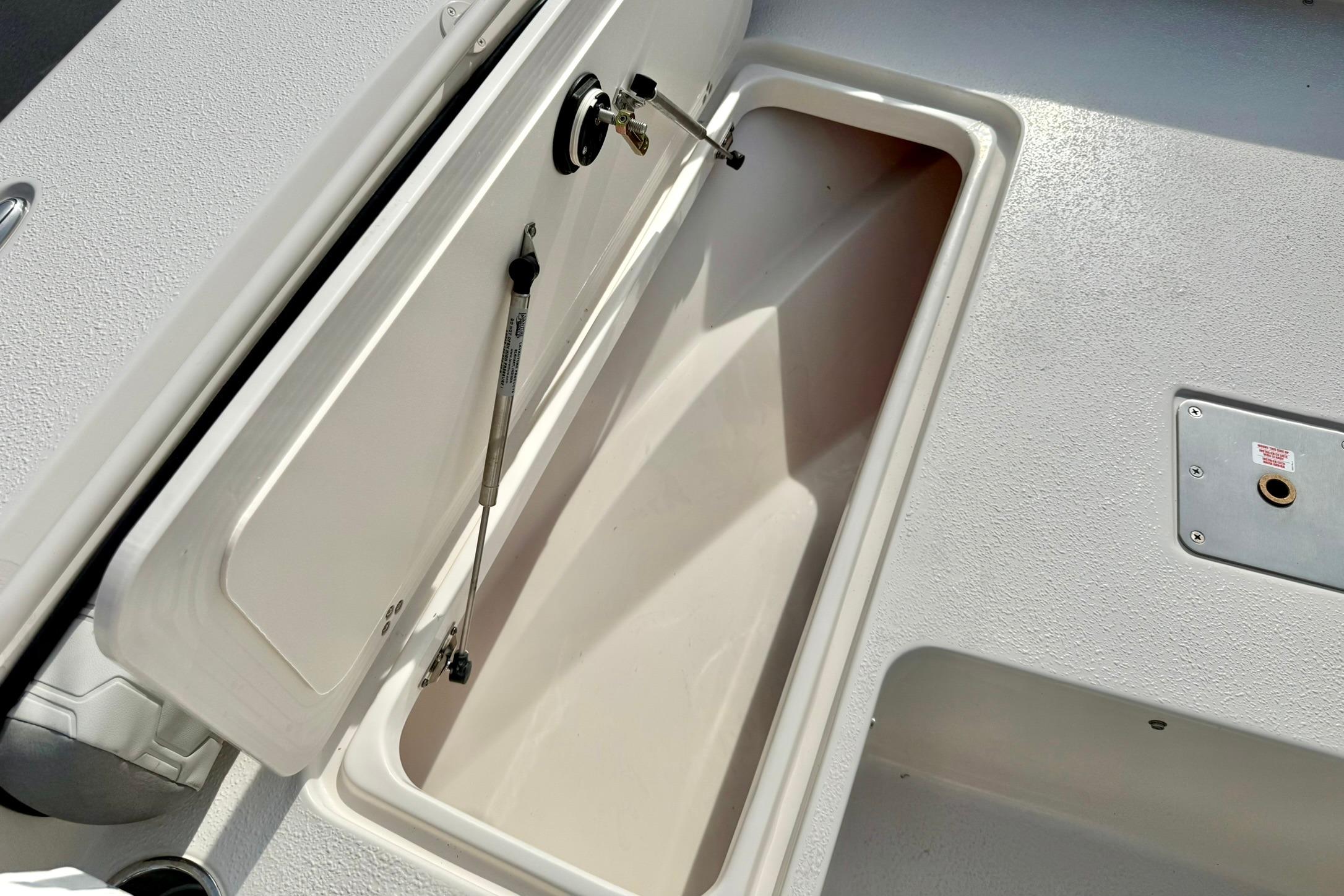 Open storage compartment on 2026 Carolina Skiff 24 Ultra Elite boat deck.