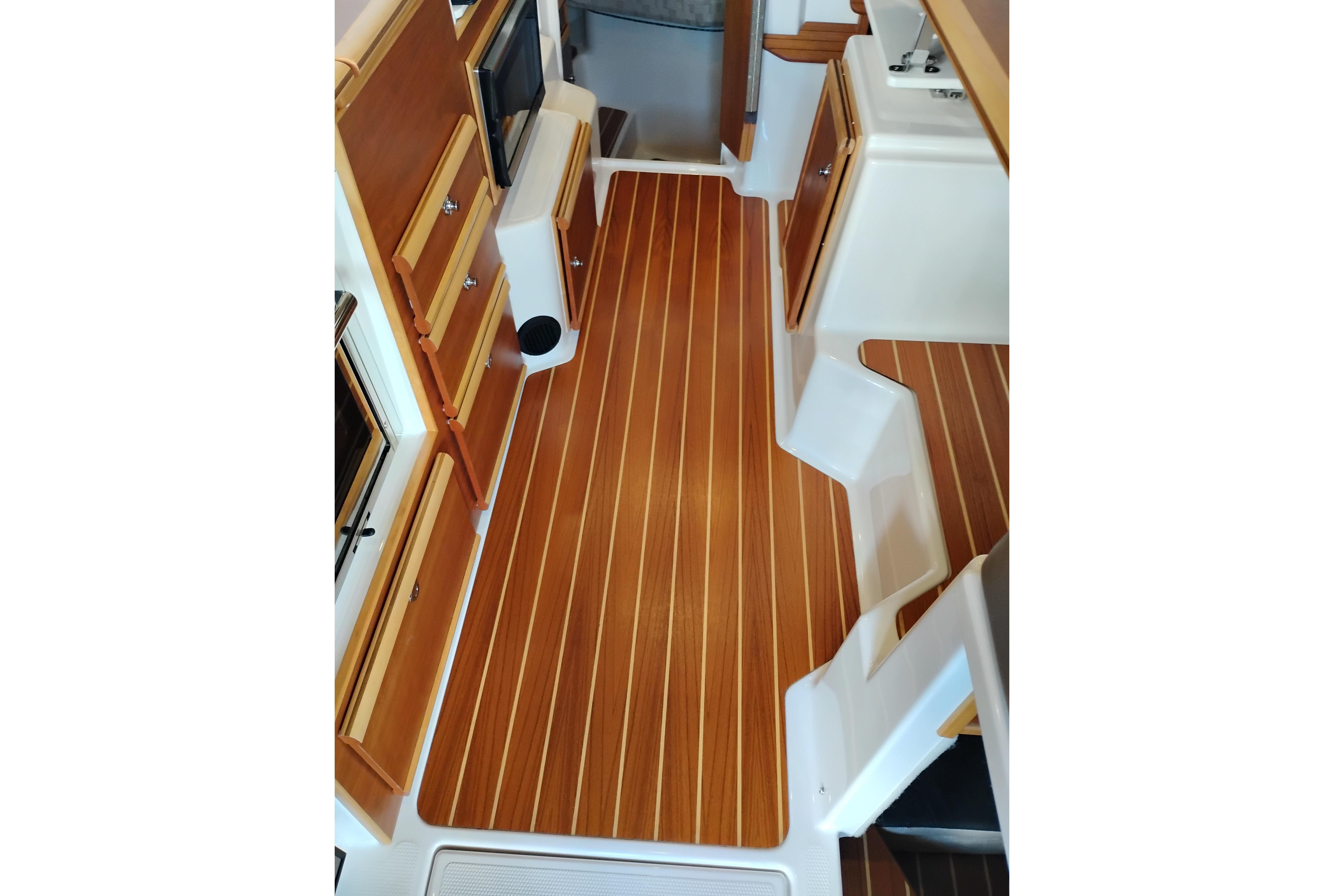 Interior of 2022 Cutwater C-32 Coupe with wood flooring and cabinetry.