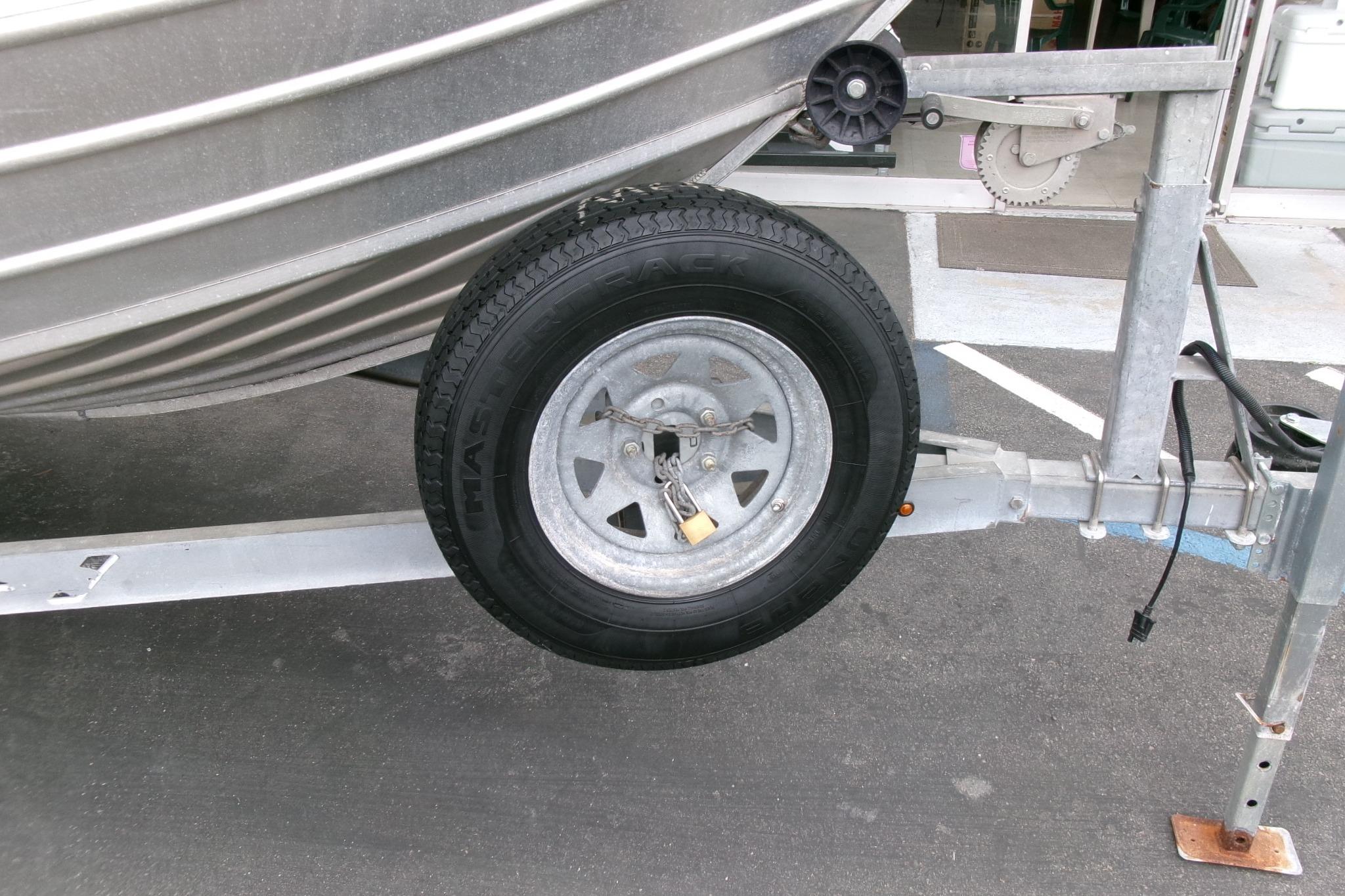 2017 Klamath Bayrunner 19 Baja boat trailer with spare tire on asphalt.