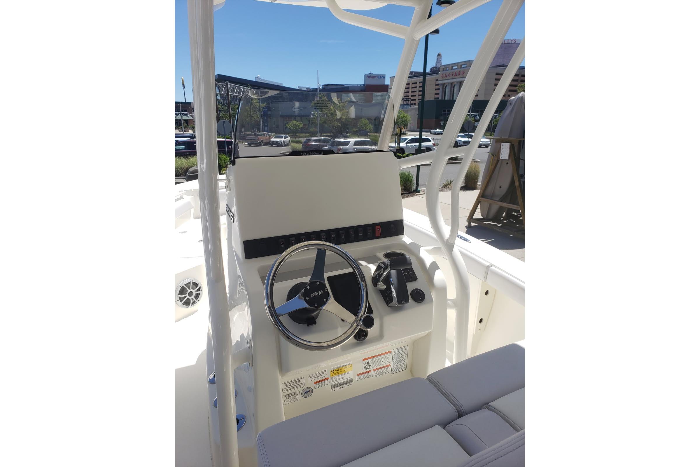 2026 Mako 226 Center Console boat interior with steering wheel and controls.
