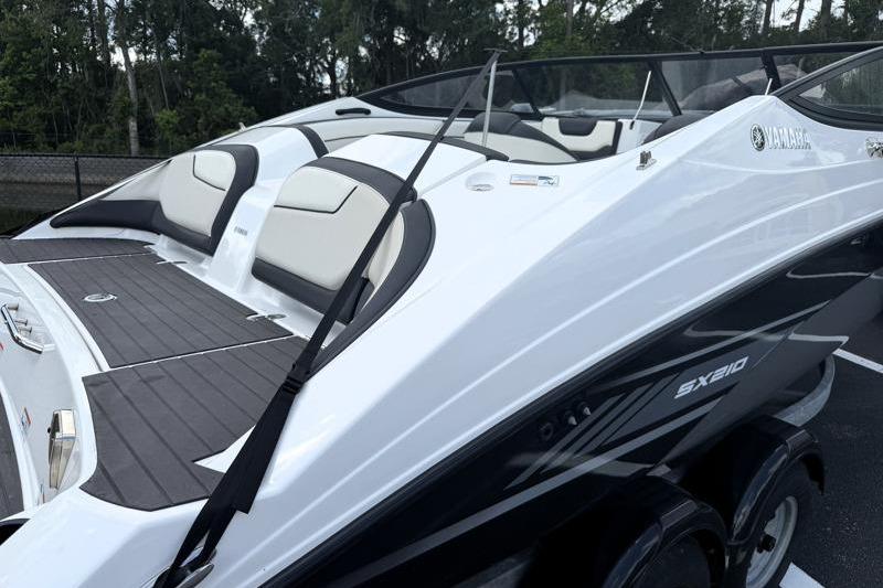 2017 Yamaha Boats SX210, sleek white and black design, parked outdoors.