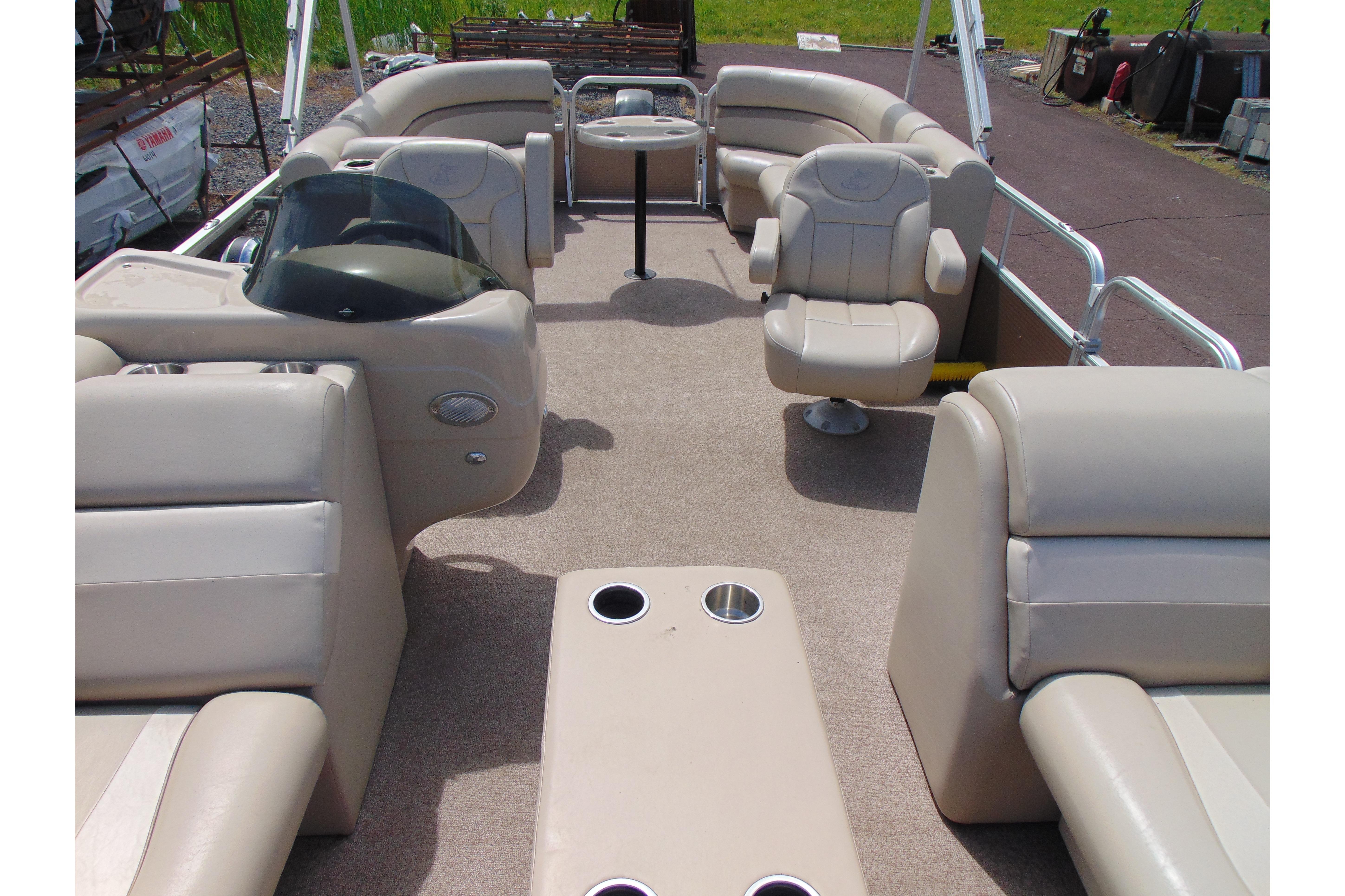 2016 Misty Harbor 245 Adventure CU pontoon boat interior with beige seating and helm.