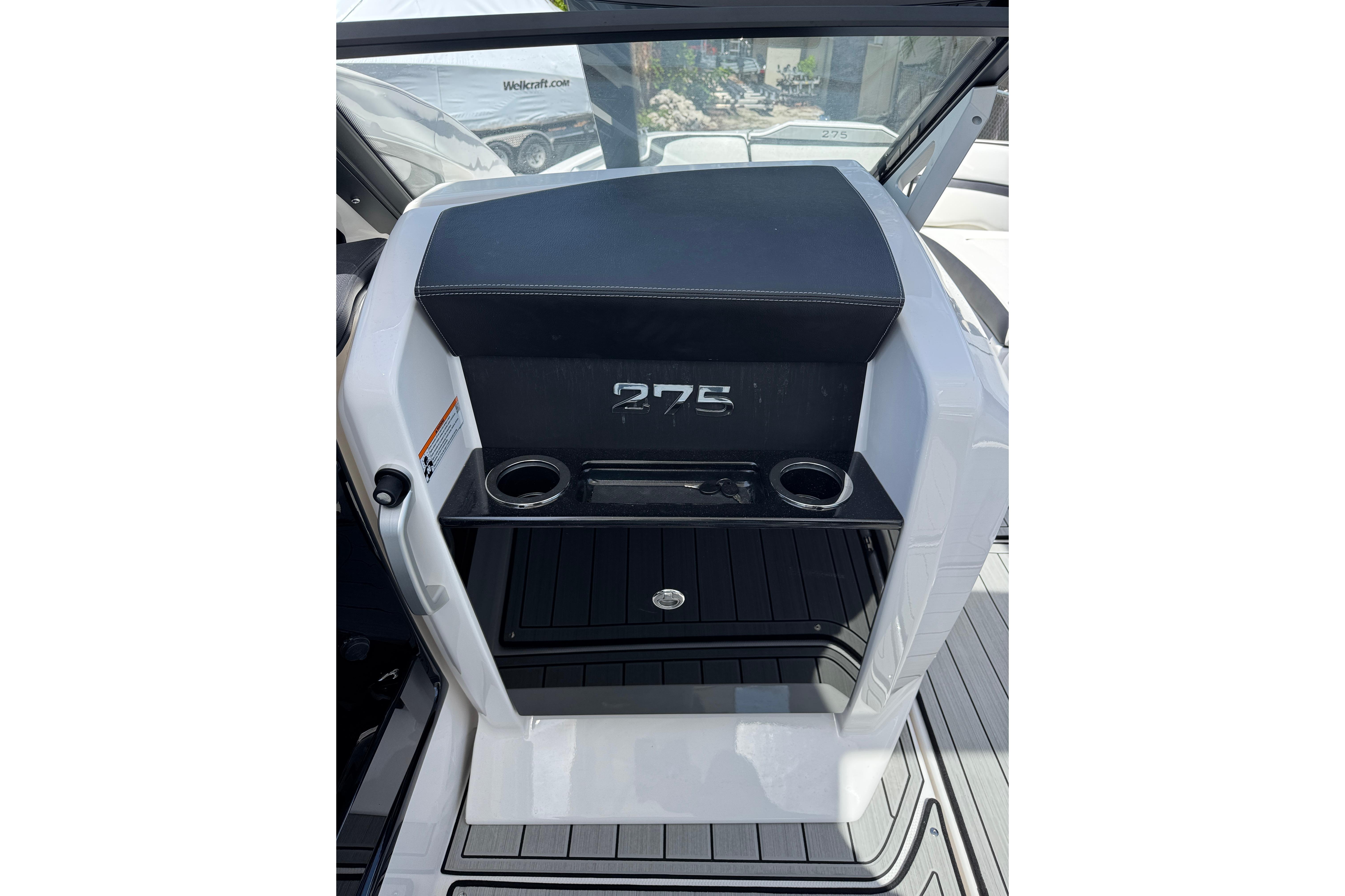 2026 Yamaha Boats 275SD interior with cup holders and storage compartment.