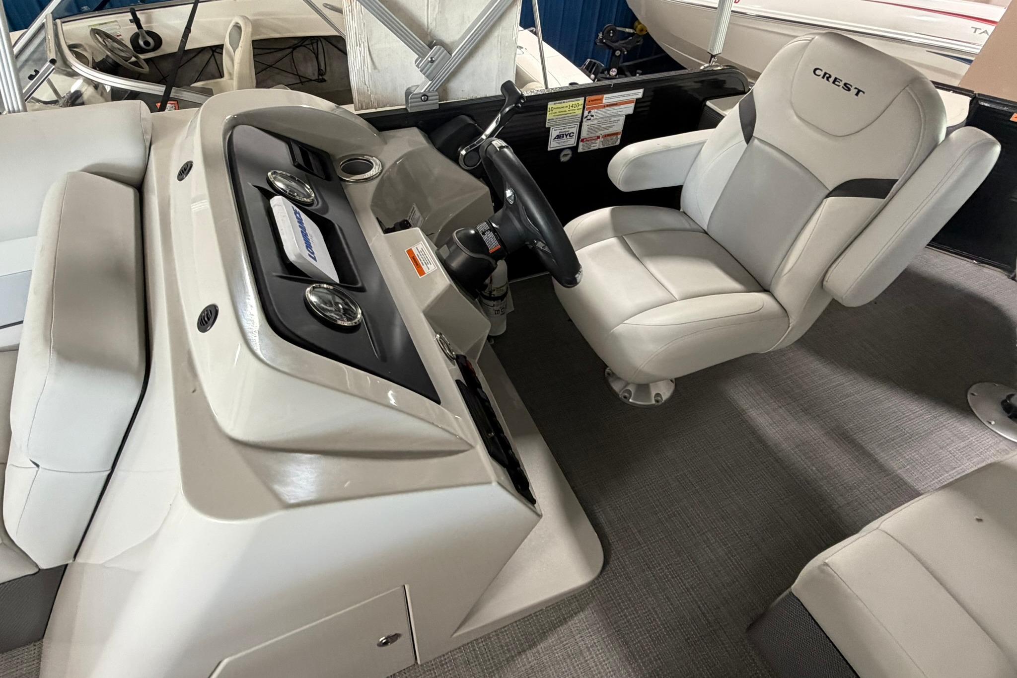 2023 Crest Classic LX 200 boat interior with steering console and captain's chair.