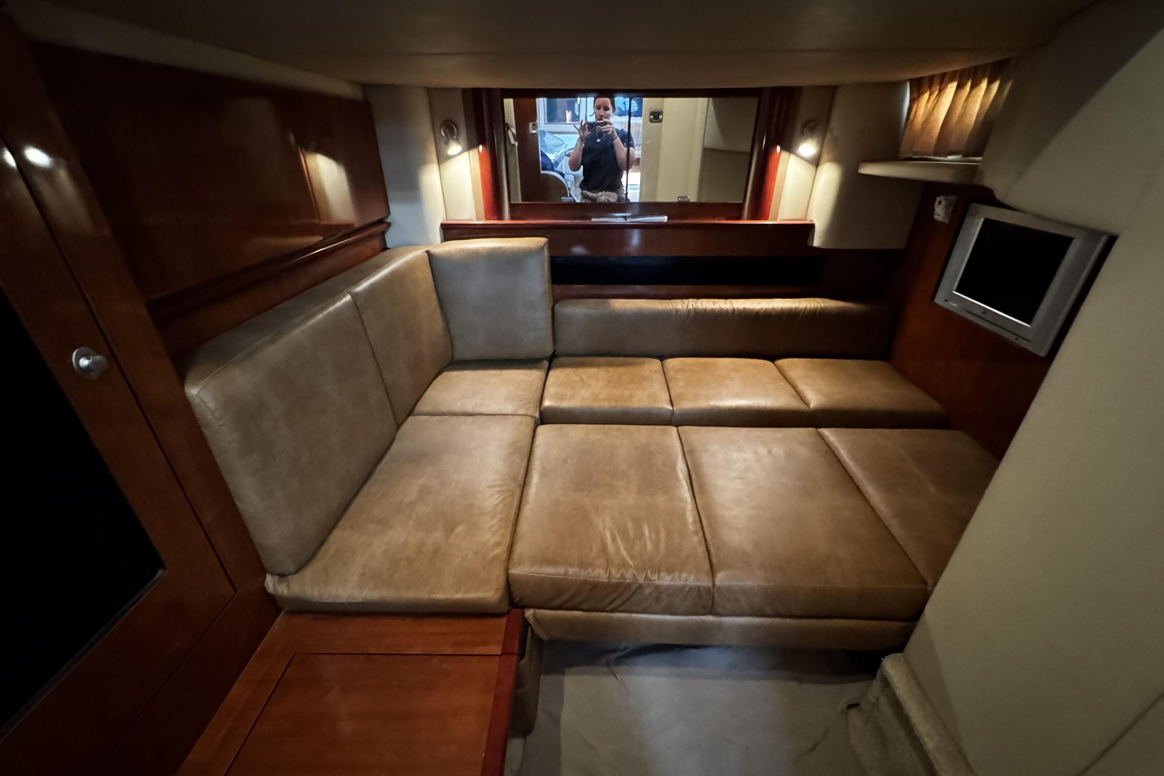 Luxurious interior of 2006 Sea Ray 40 Sundancer yacht with leather seating and TV.
