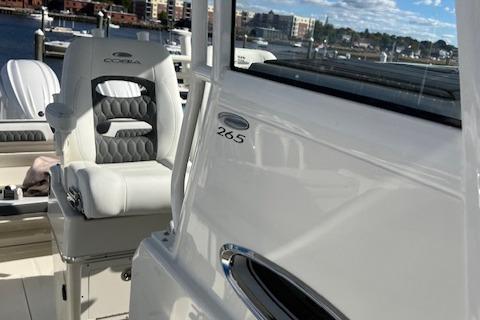 2025 Cobia 265 Center Console Open boat interior with seating and dock view.