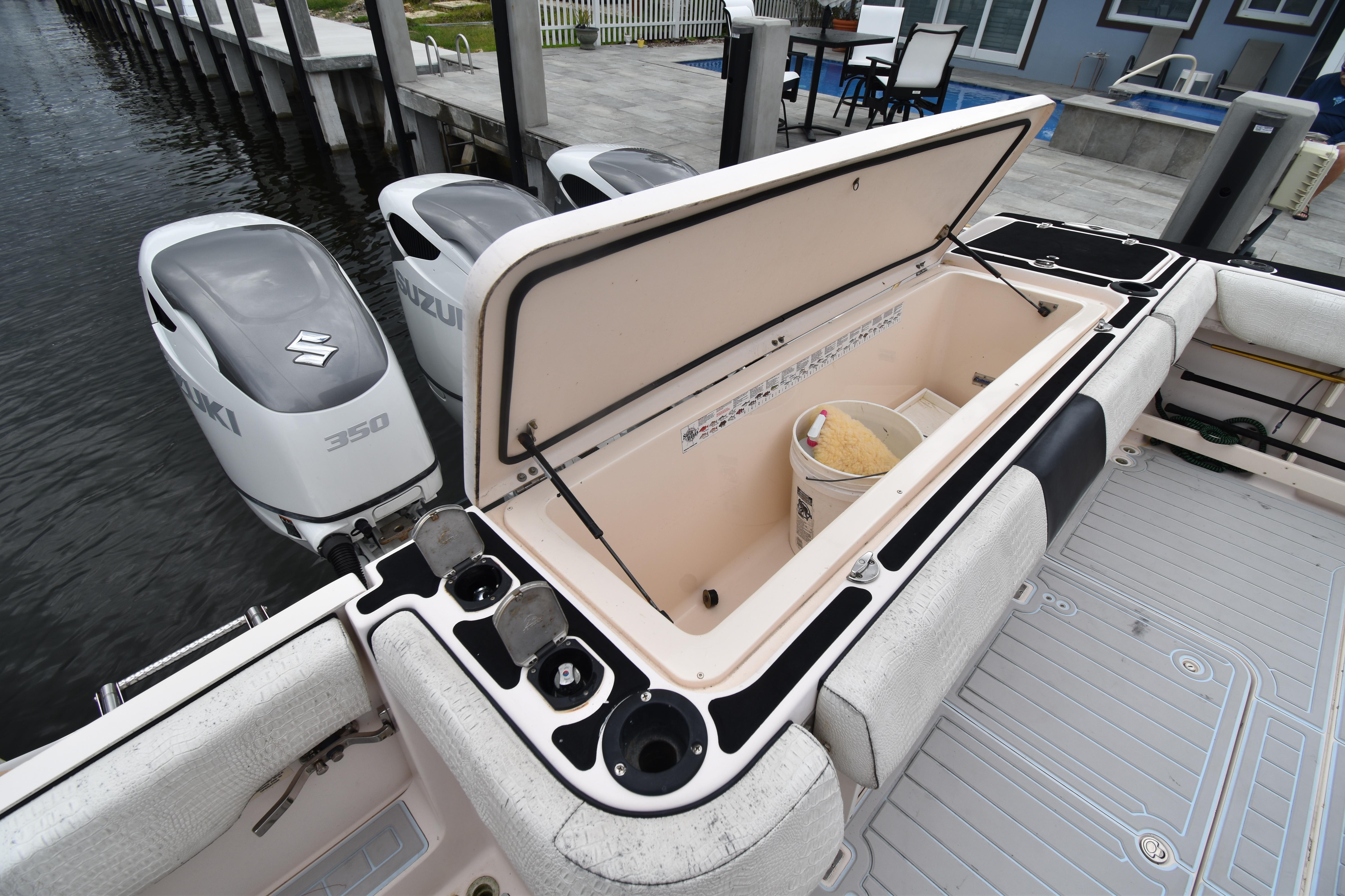 2010 Grady-White Canyon 366 boat with Suzuki 350 engines and open storage compartment.