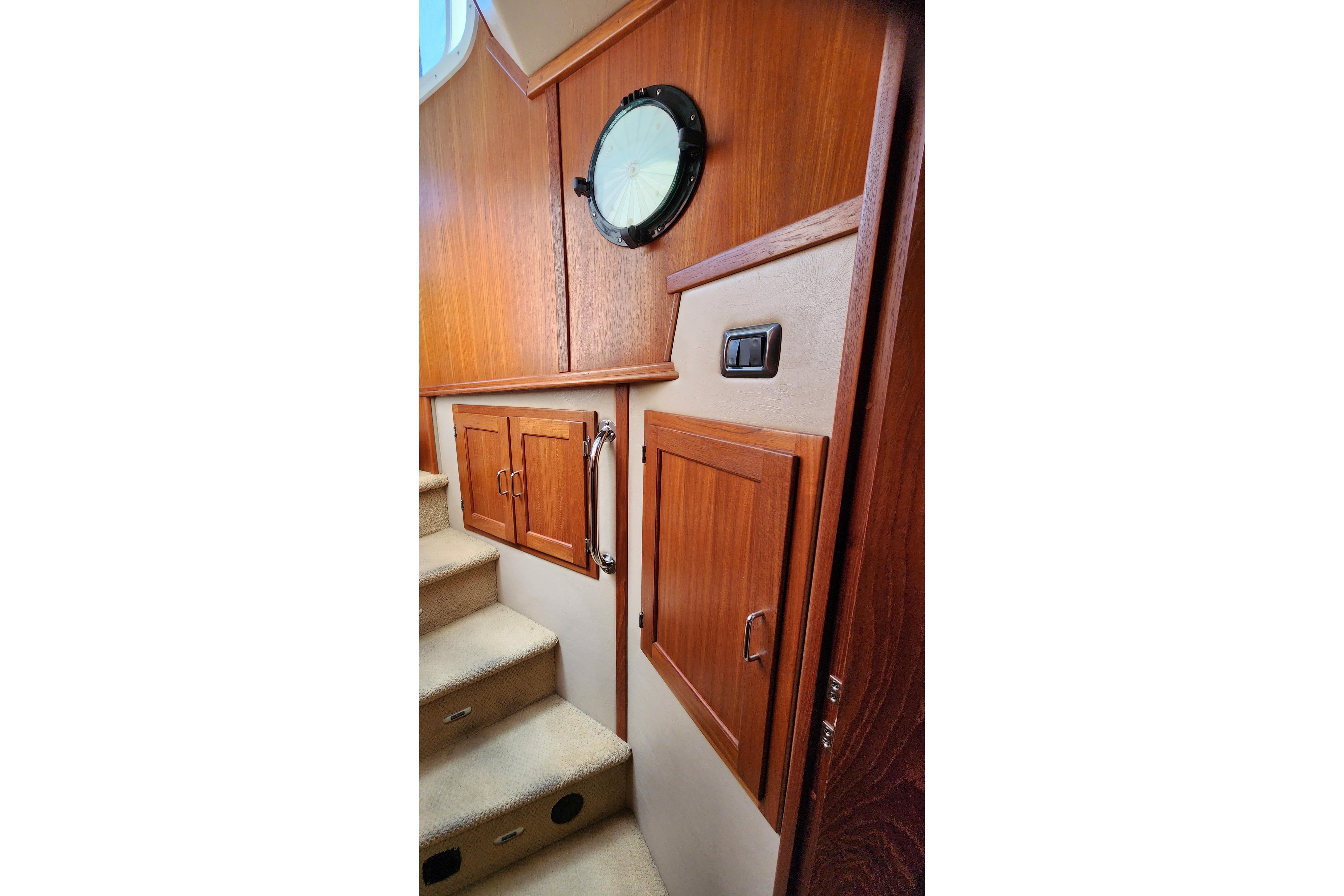 Interior of 2006 American Tug AT with wooden cabinetry and stairs.
