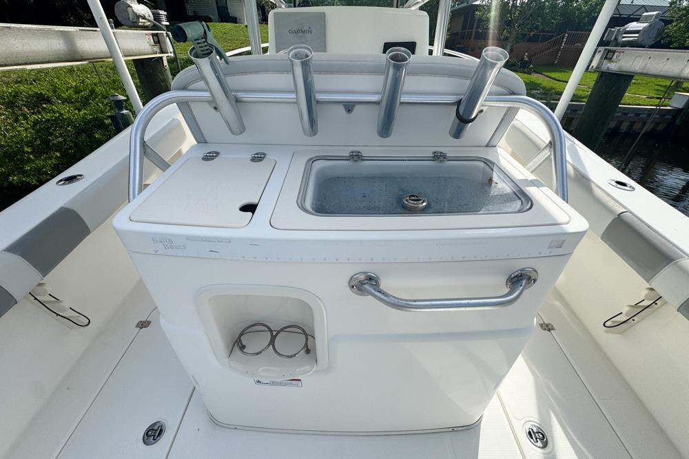 2018 Mako 284 Center Console boat with fishing rod holders and sink station.