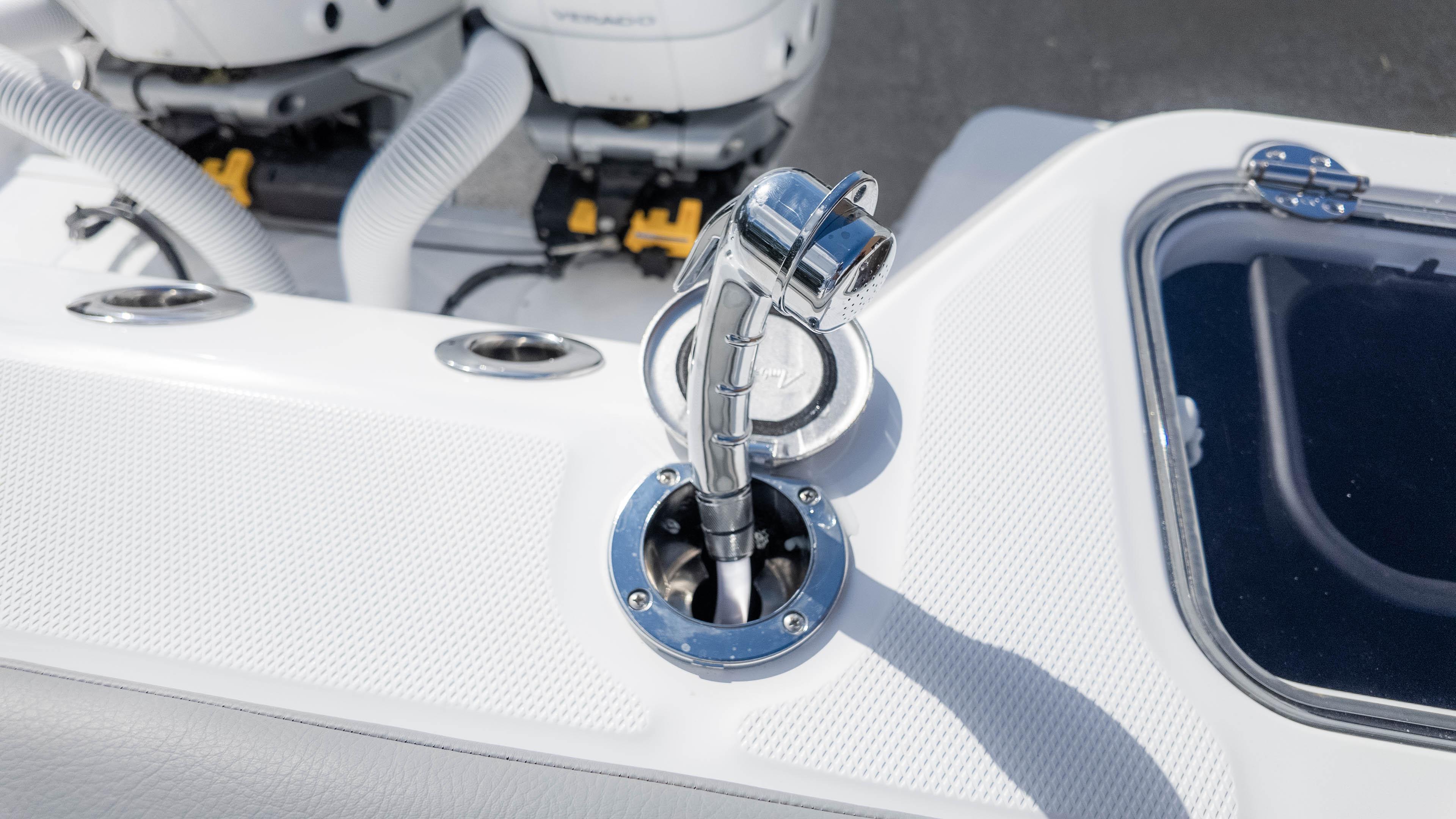 2025 Everglades 315 Center Console boat detail with chrome fittings and engine components.