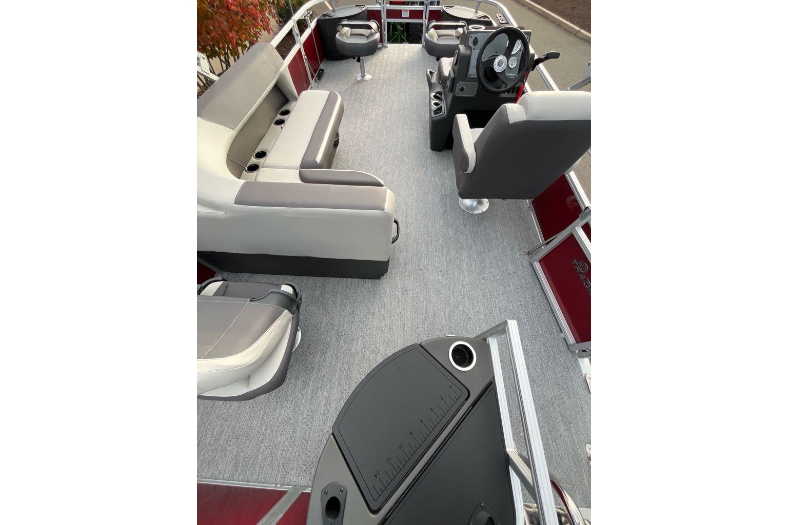2026 Sun Tracker Bass Buggy 18 DLX pontoon boat interior with seating and steering console.
