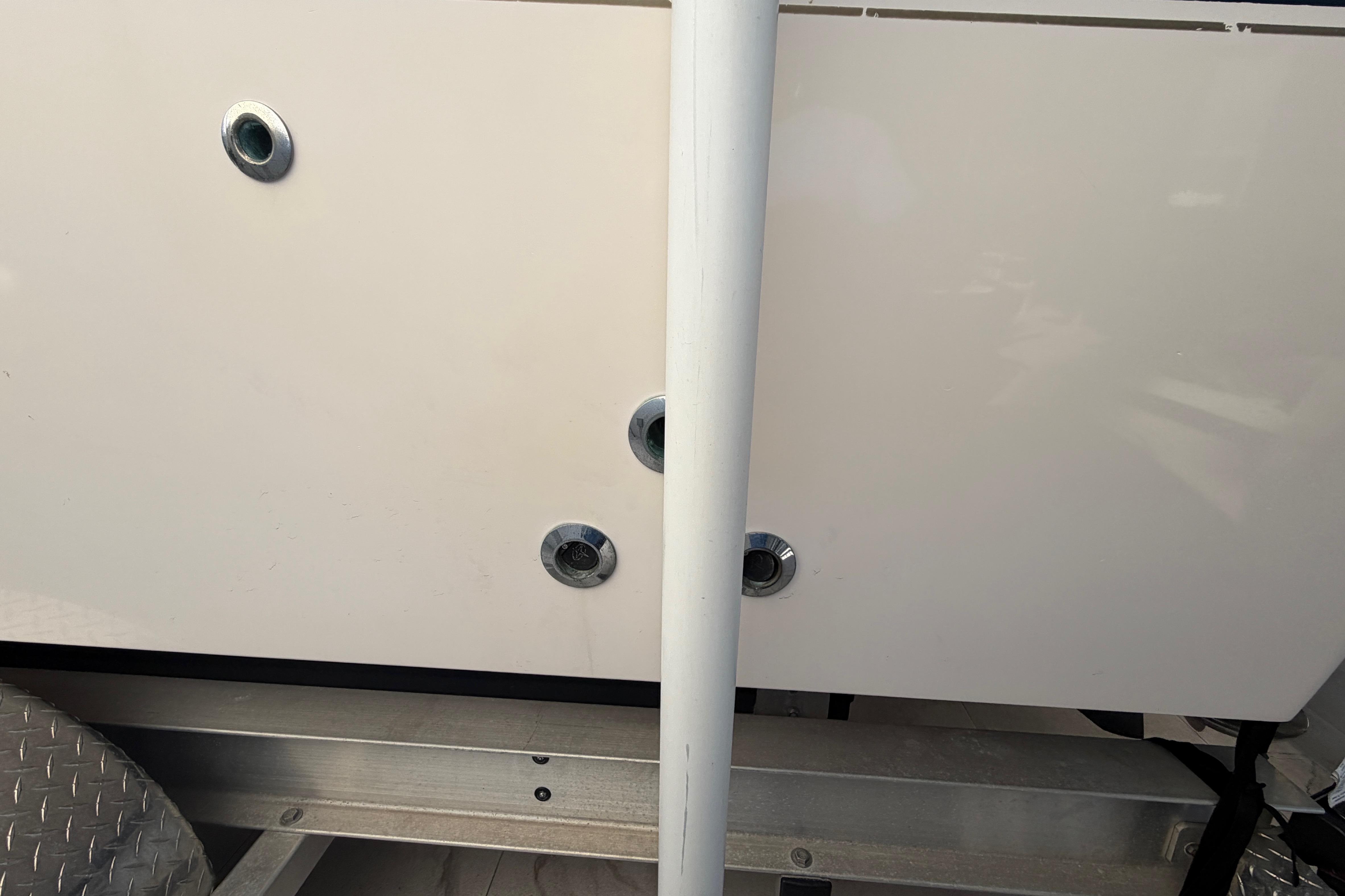 Close-up of a 2004 Grady White 273 boat hull with metal fittings.
