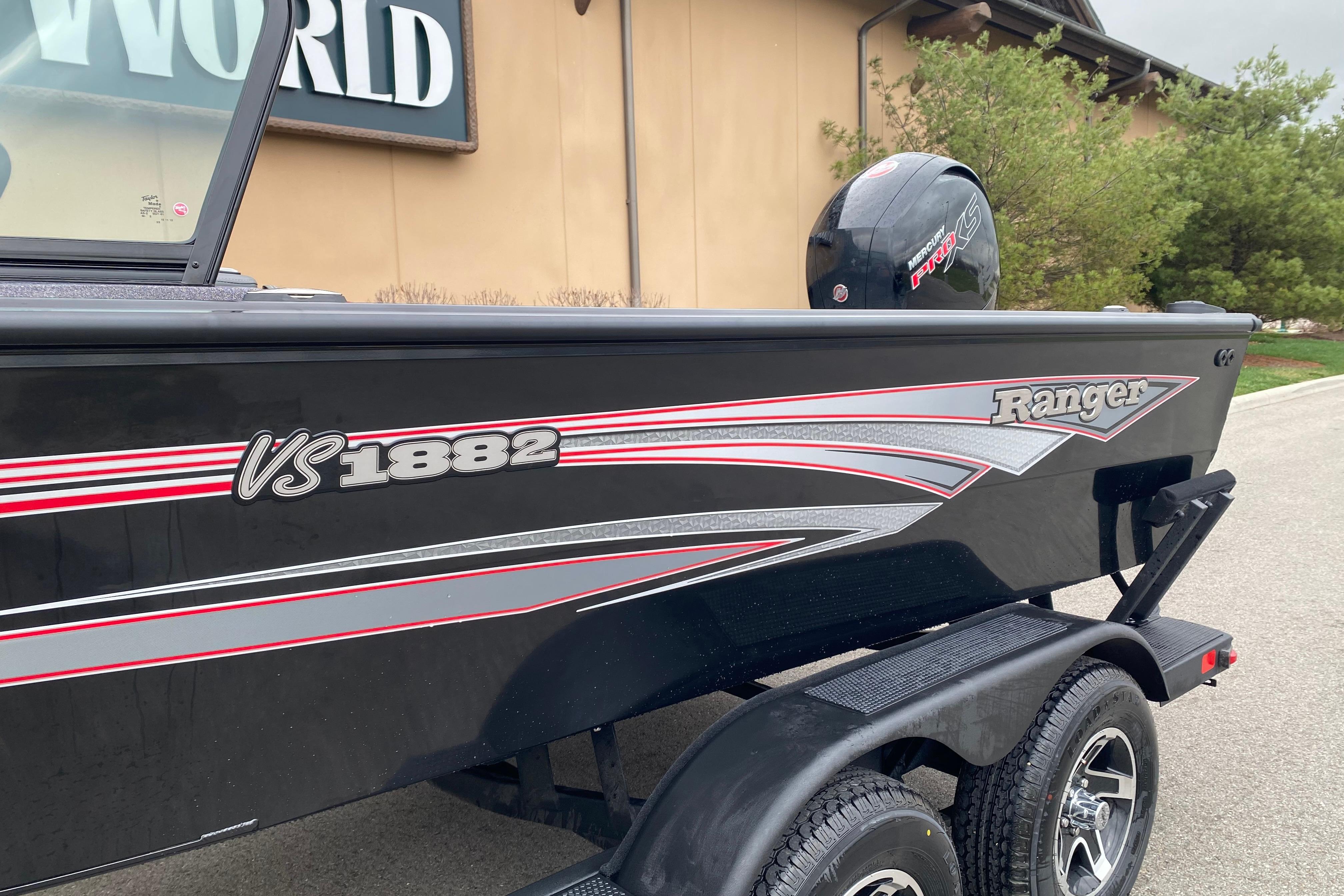 2026 Ranger VS1882SC Angler boat with sleek black and red design on trailer.