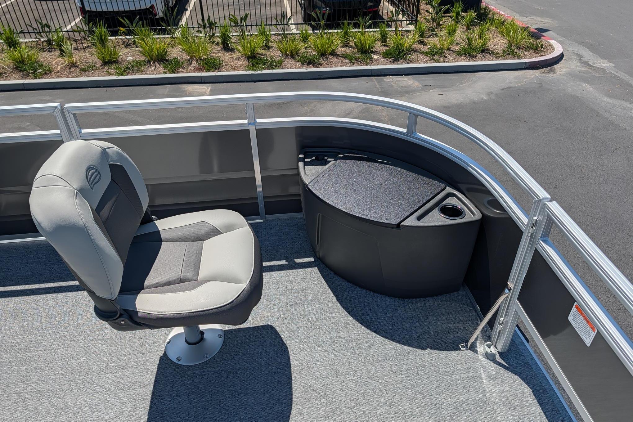 2026 Sun Tracker Fishin' Barge 22 DLX boat interior with seating and storage.