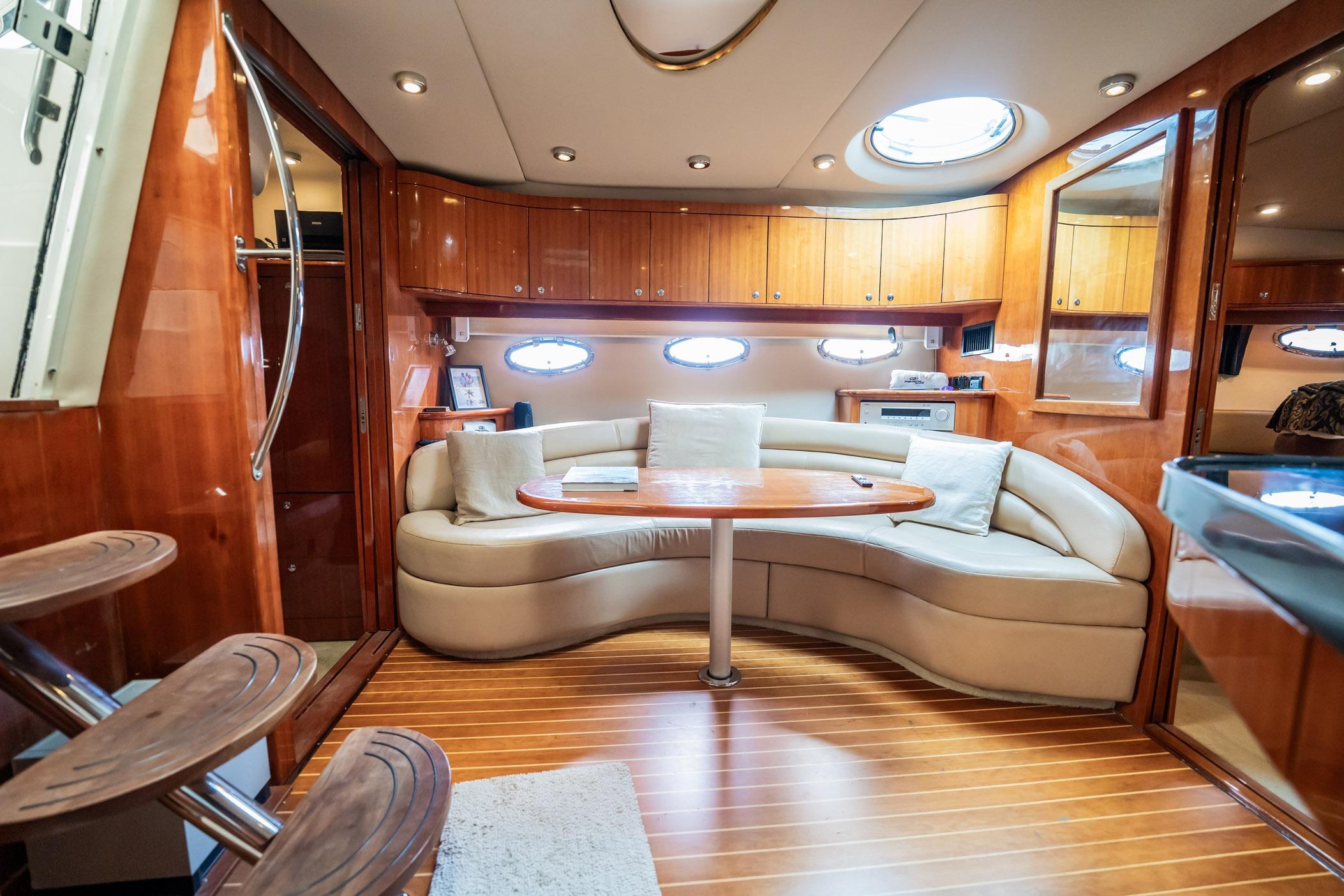 Luxurious interior of 2008 Regal Commodore 4460 yacht with elegant wood finishes and plush seating.