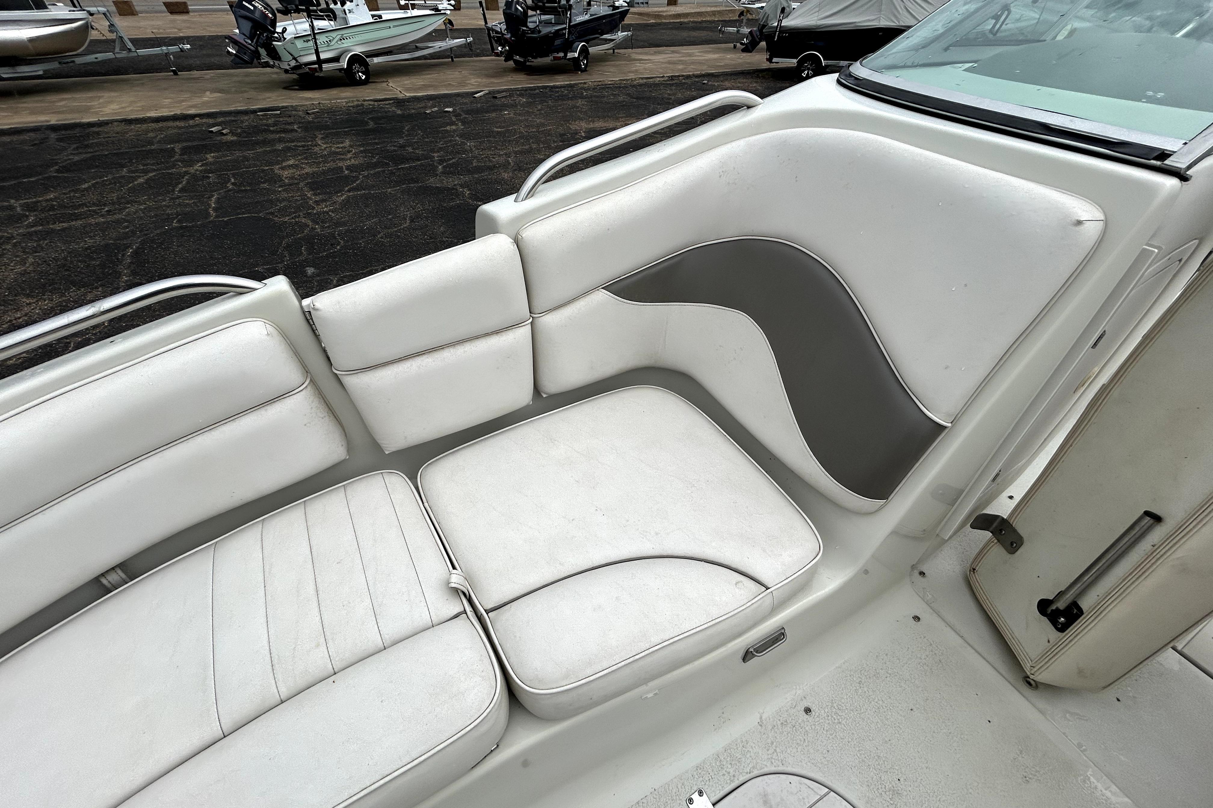 White seating area on a 2001 Crownline 239 DB boat, featuring sleek design and comfortable cushions.