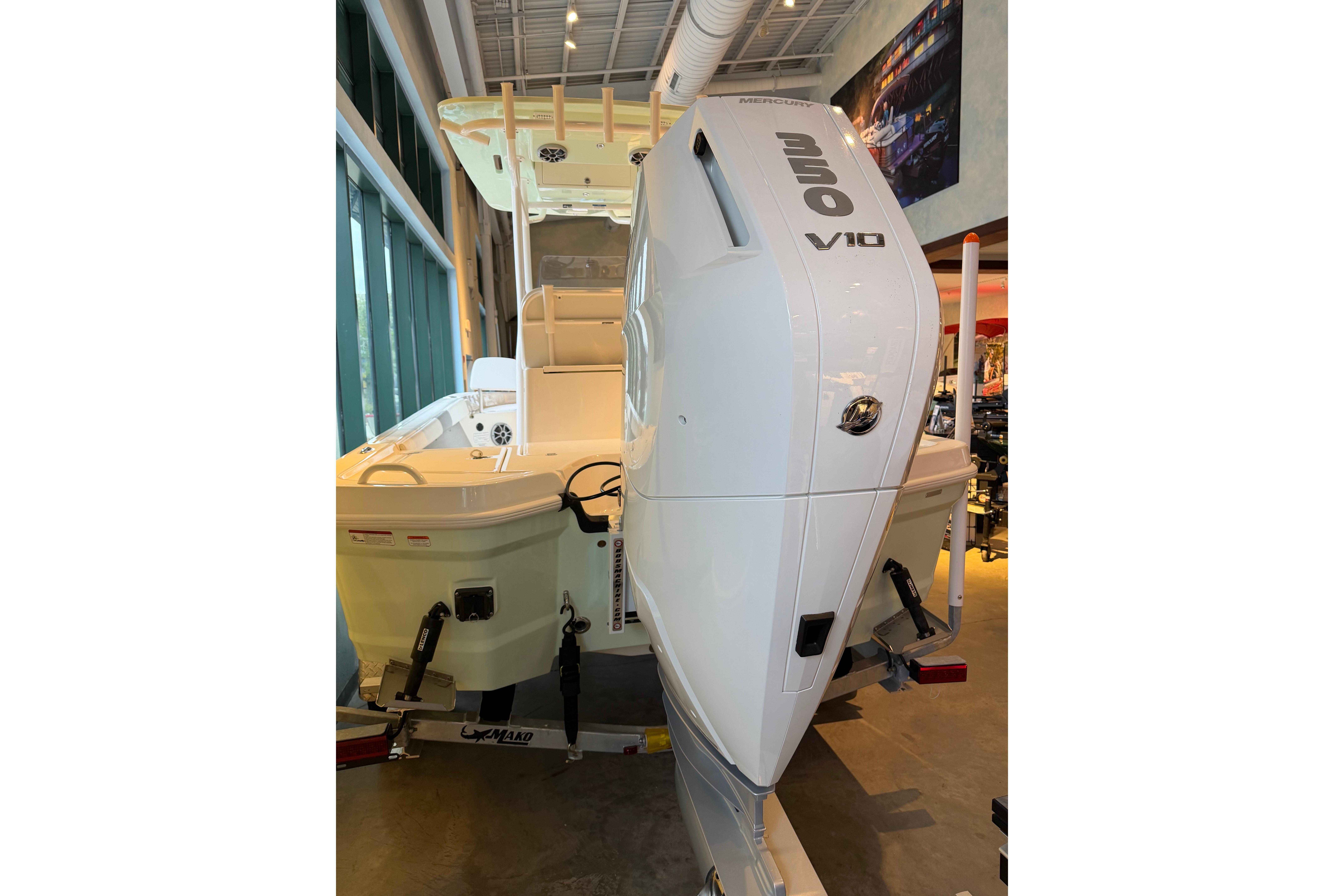 2026 Mako 24 APEX boat with powerful V10 engine displayed indoors.