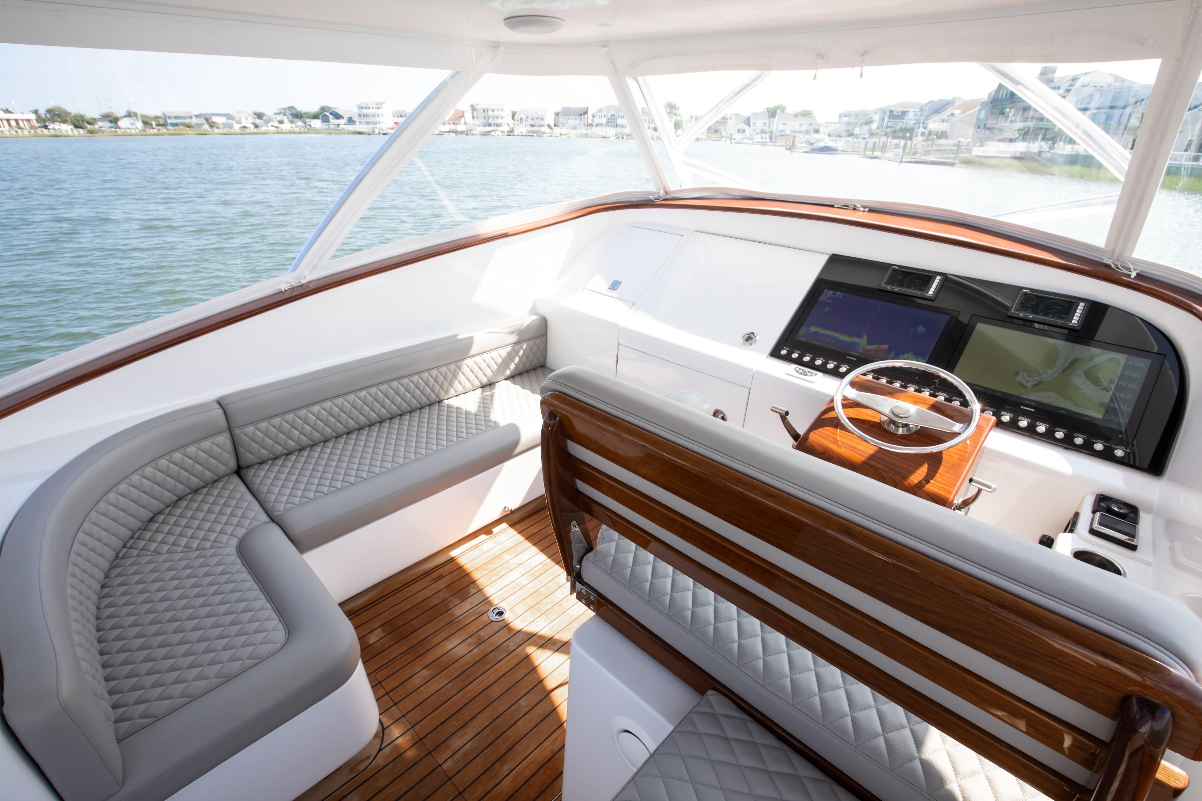 Luxurious interior of 2026 Release Boatworks 46 Walkaround with elegant seating and advanced navigation displays.